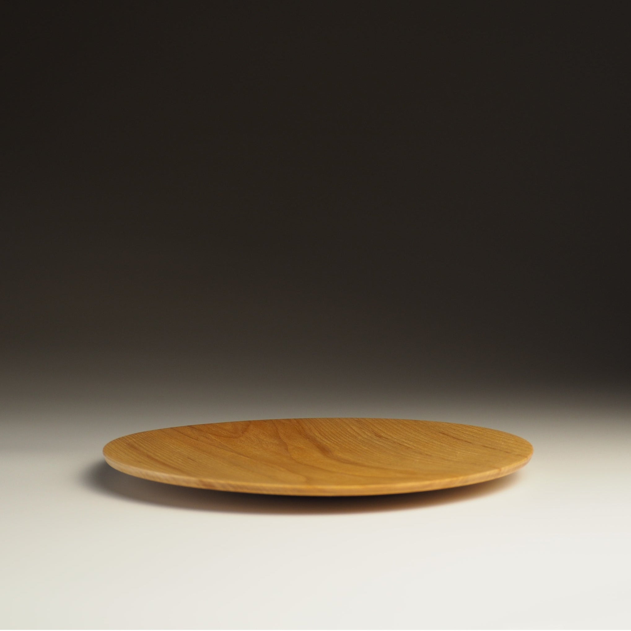 Japanese wood plate on shaded background, Tsukushi.