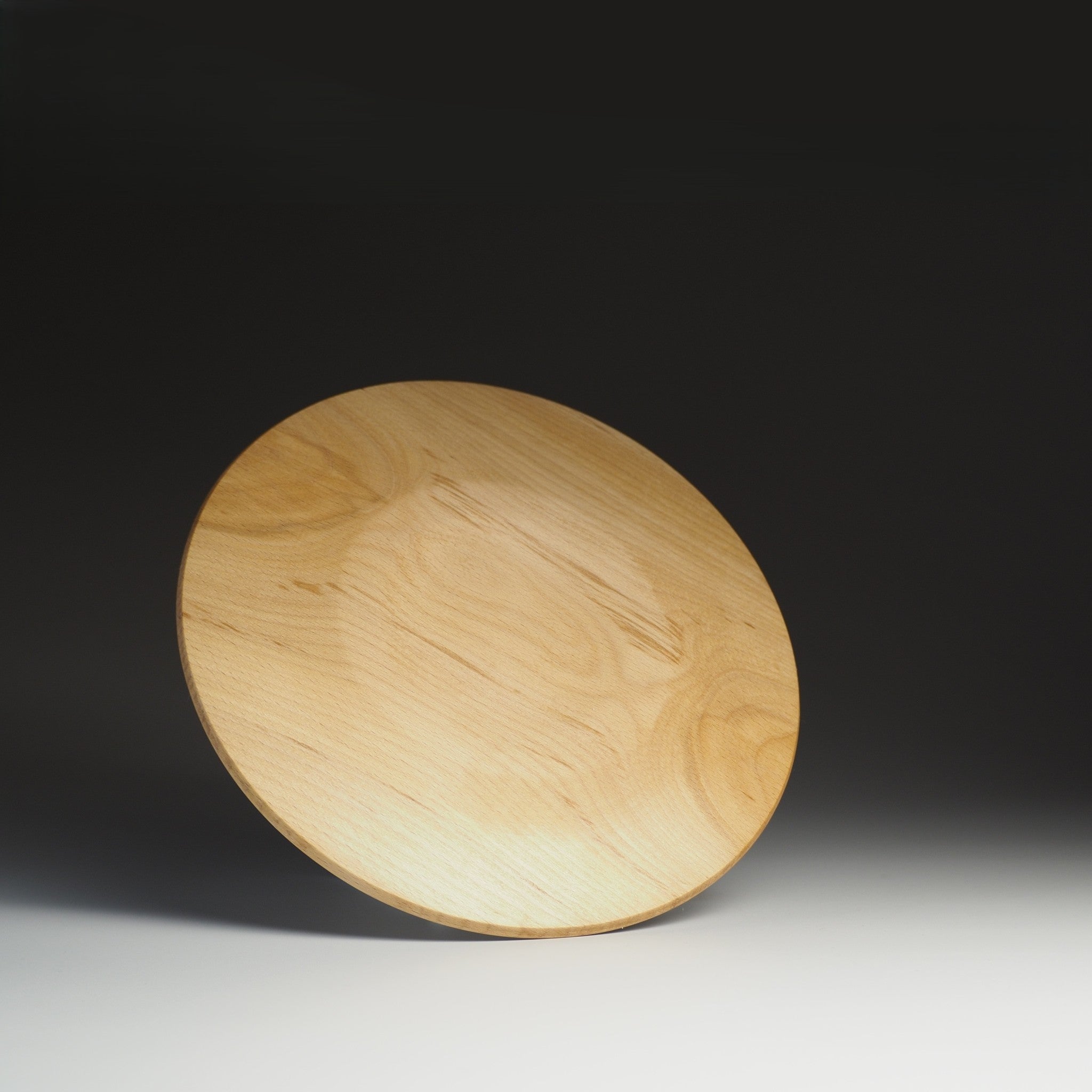 Wooden plate on shaded background from Japan, Tsukushi.