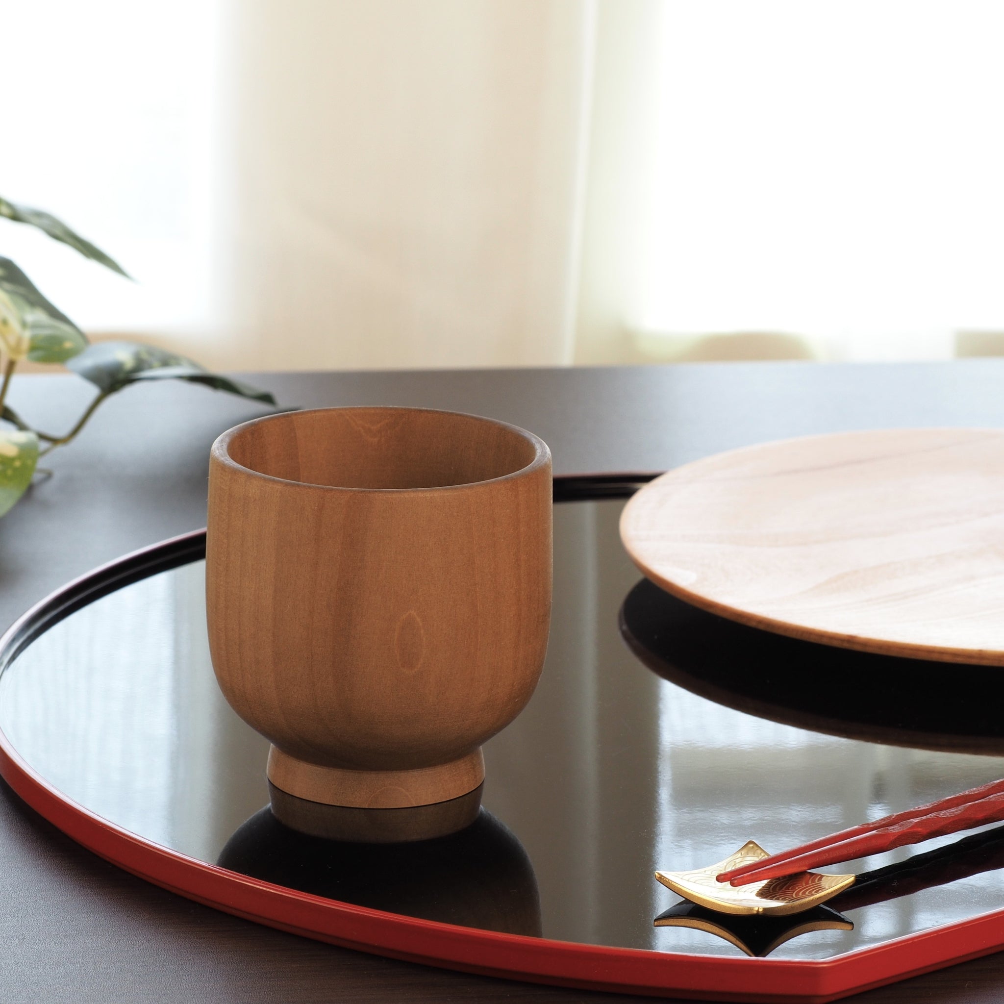 Japanese handcrafted Wooden Teacup on lifestyle background. Tsukushi