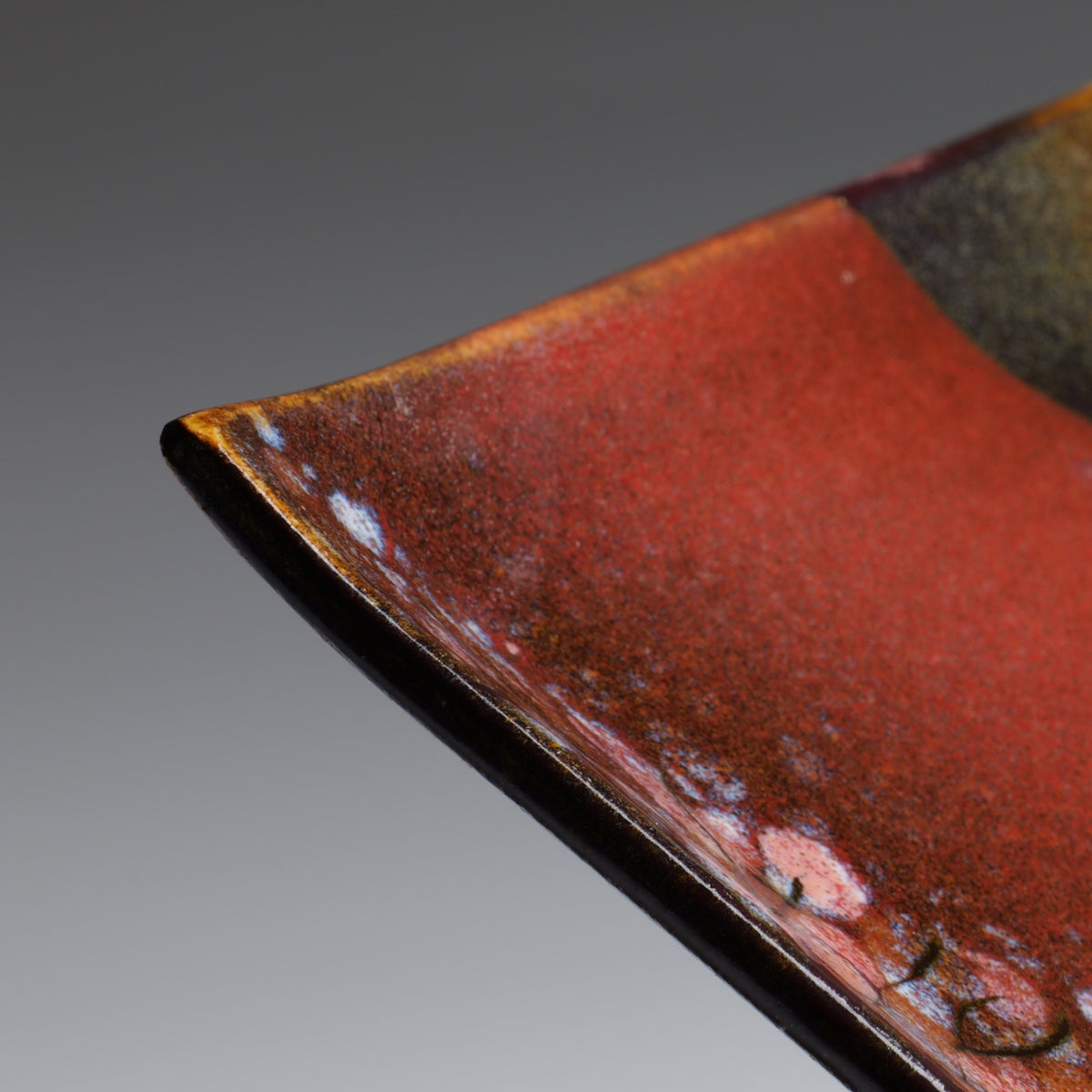 Close-up of Akafuji plate showing the iron red Nanasai Tenmoku glaze