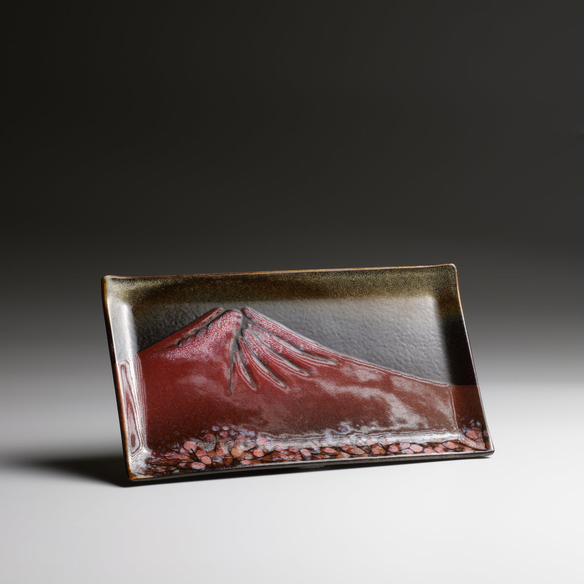 Angled view of Akafuji rectangular ceramic plate with layered Nanasai Tenmoku glaze