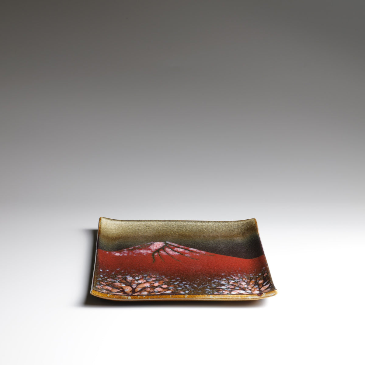 Front view of the Akafuji Japanese ceramic plate, featuring a red Mount Fuji landscape and gently raised edges against a neutral background.