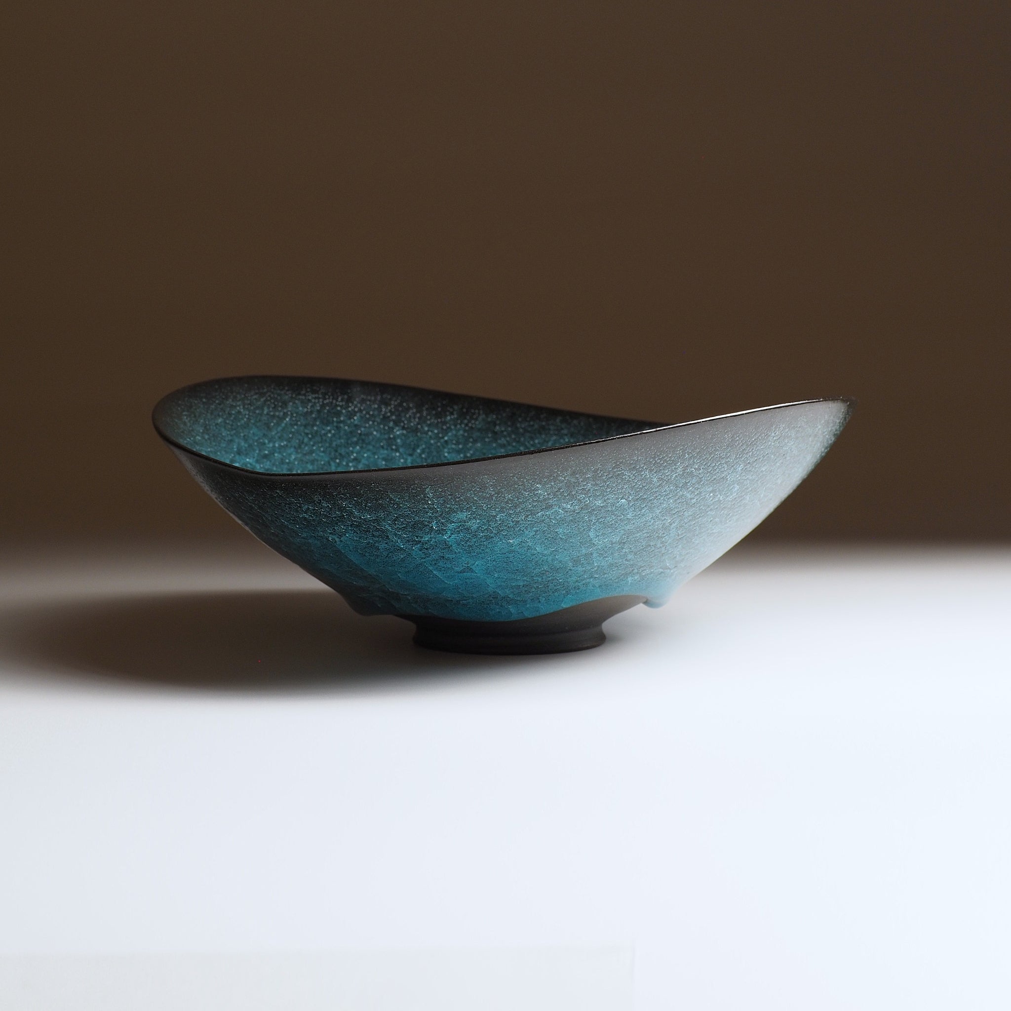 Aonami waved serving bowl, front central view showing full wave form and teal to silver kannyu glaze. Usurai Pottery, Japan.