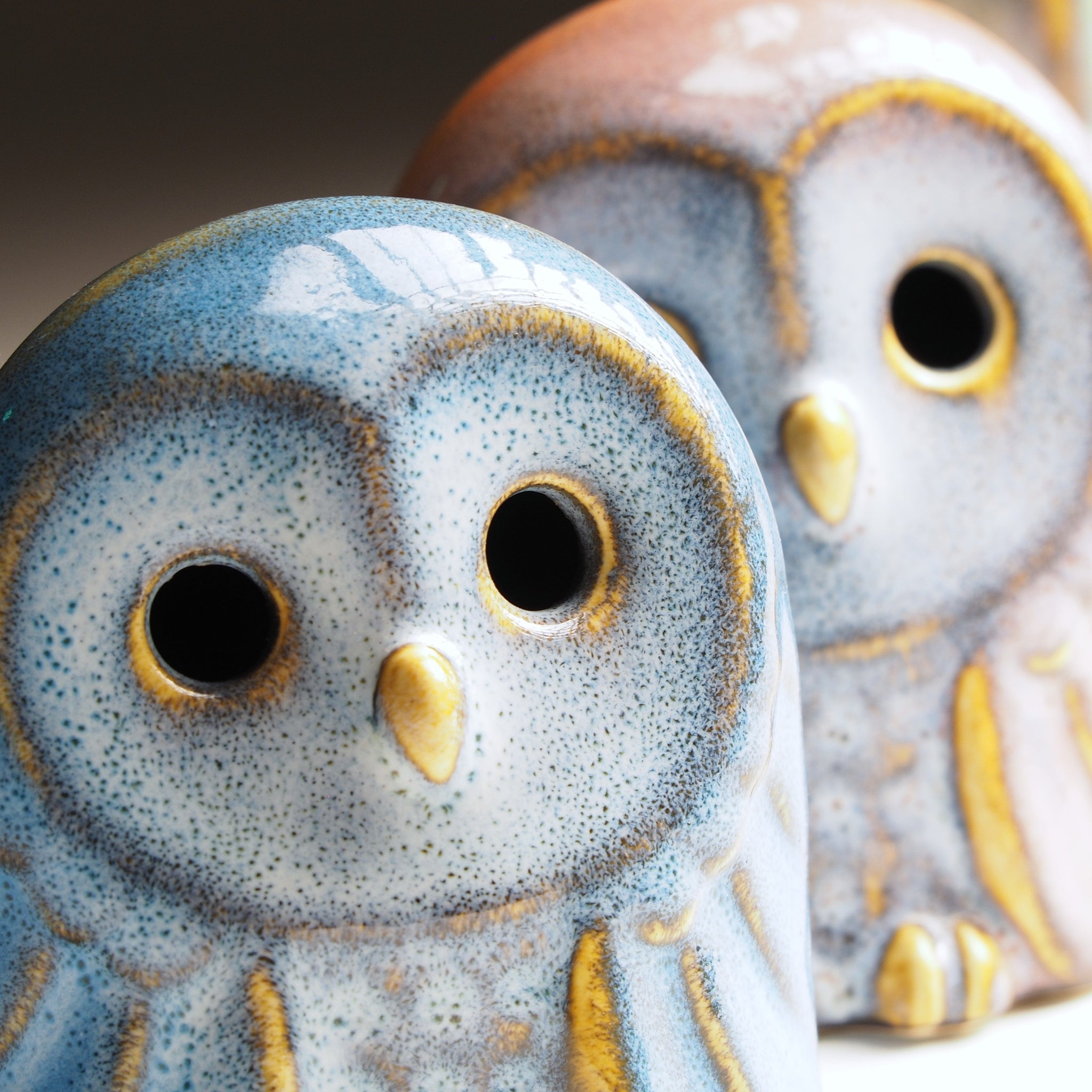 Close-up of the Engifuku ceramic owl figurine with a speckled design and gold accents.