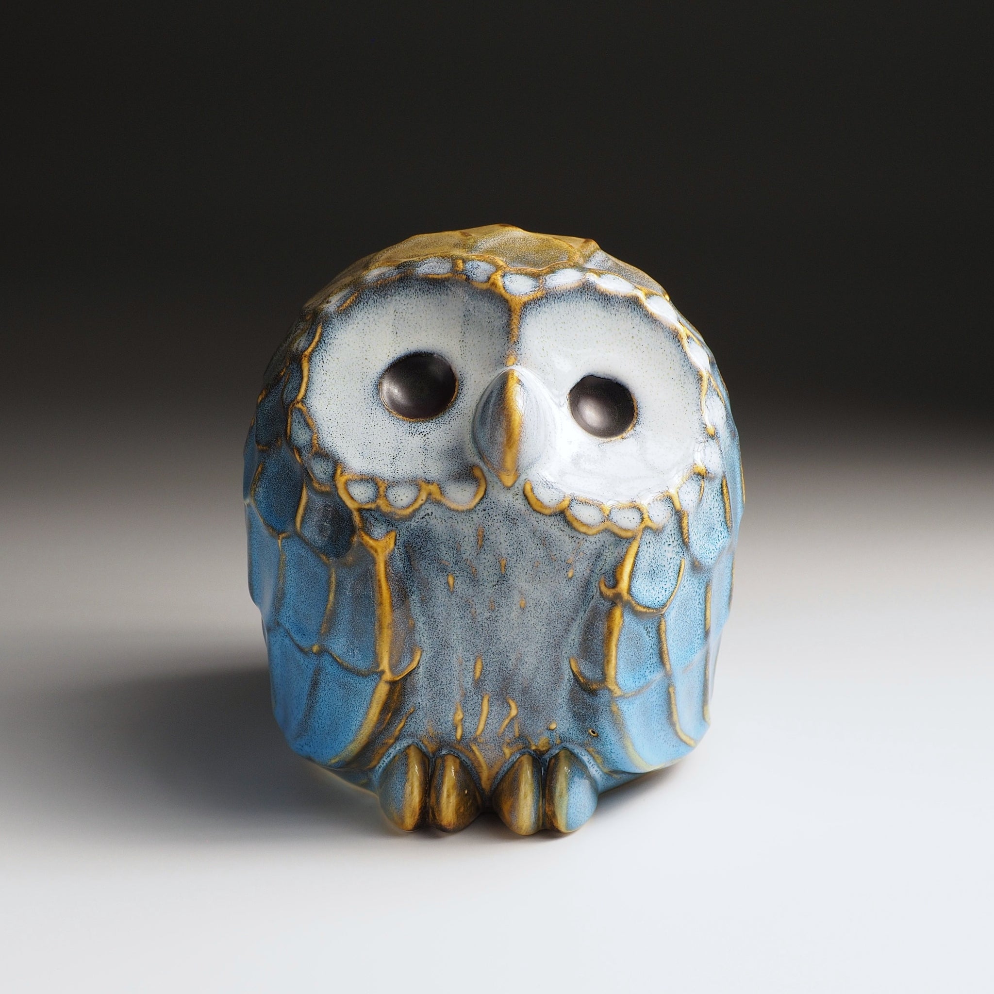 Front view of the large Fukumori ceramic owl figurine, by Kazuhiro Kojima, ivory eyes and cerulean Nanasai Tenmoku glaze, handcrafted in Japan, Tsukushi.