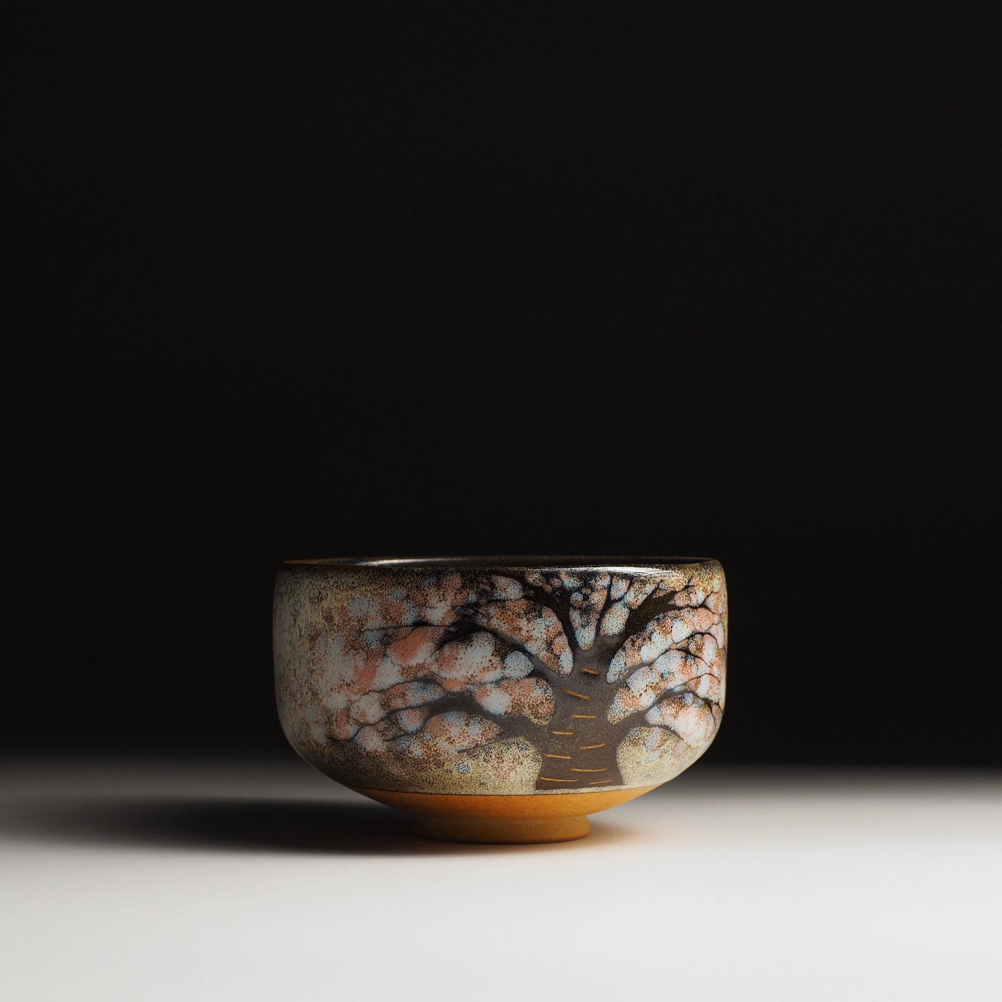 Hanagumo matcha bowl, sakura tree motif in Nanasai Tenmoku, charcoal and blush tones, Taro Kojima