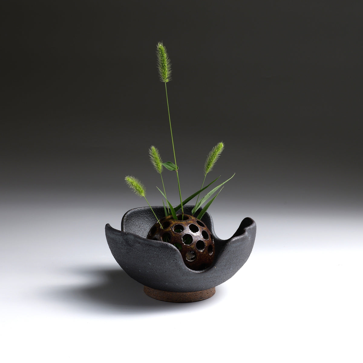 Hanamori flower frog in Yakishime ceramic with foxtail grass on a faded background