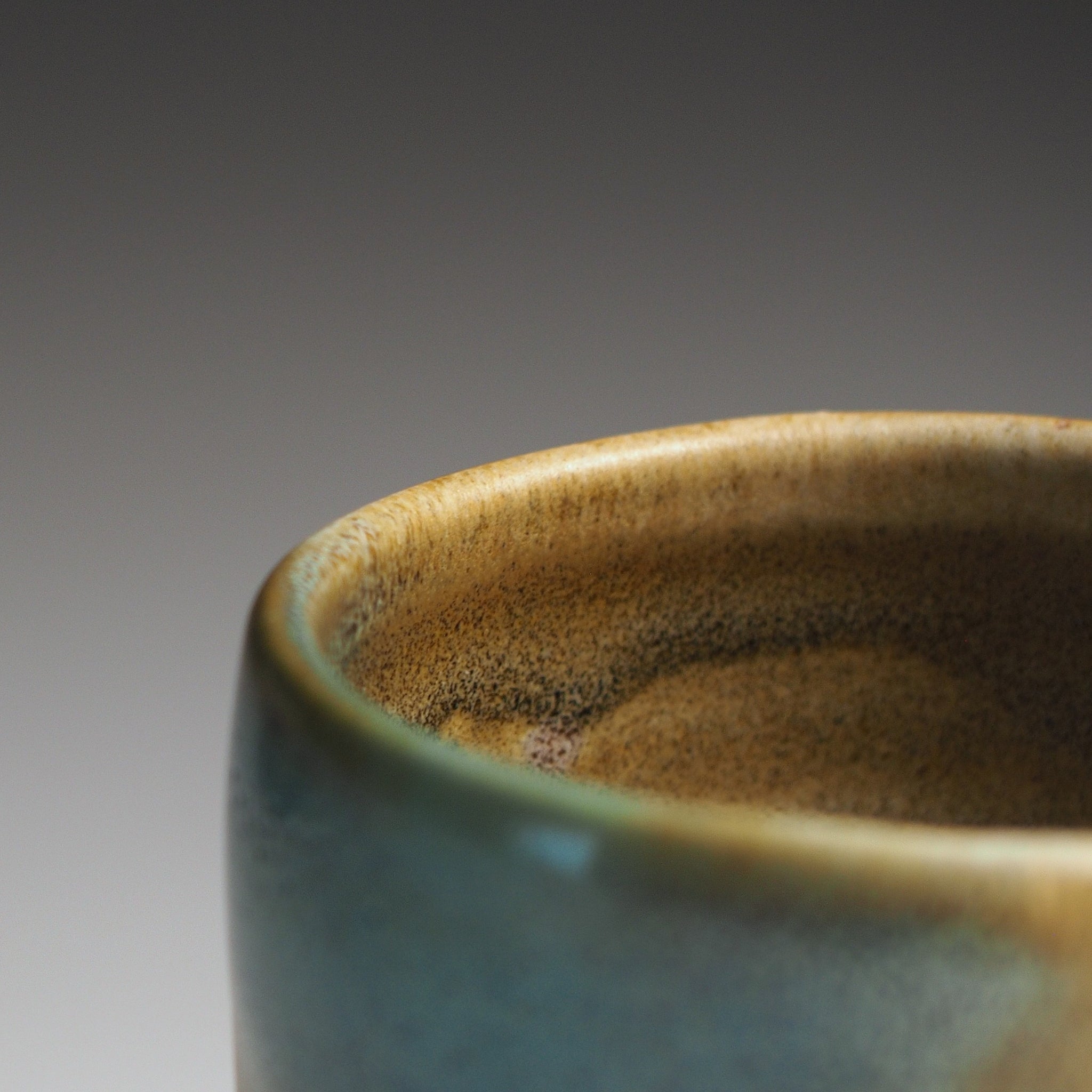 Close up of a green and brown Japanese Sake cup
