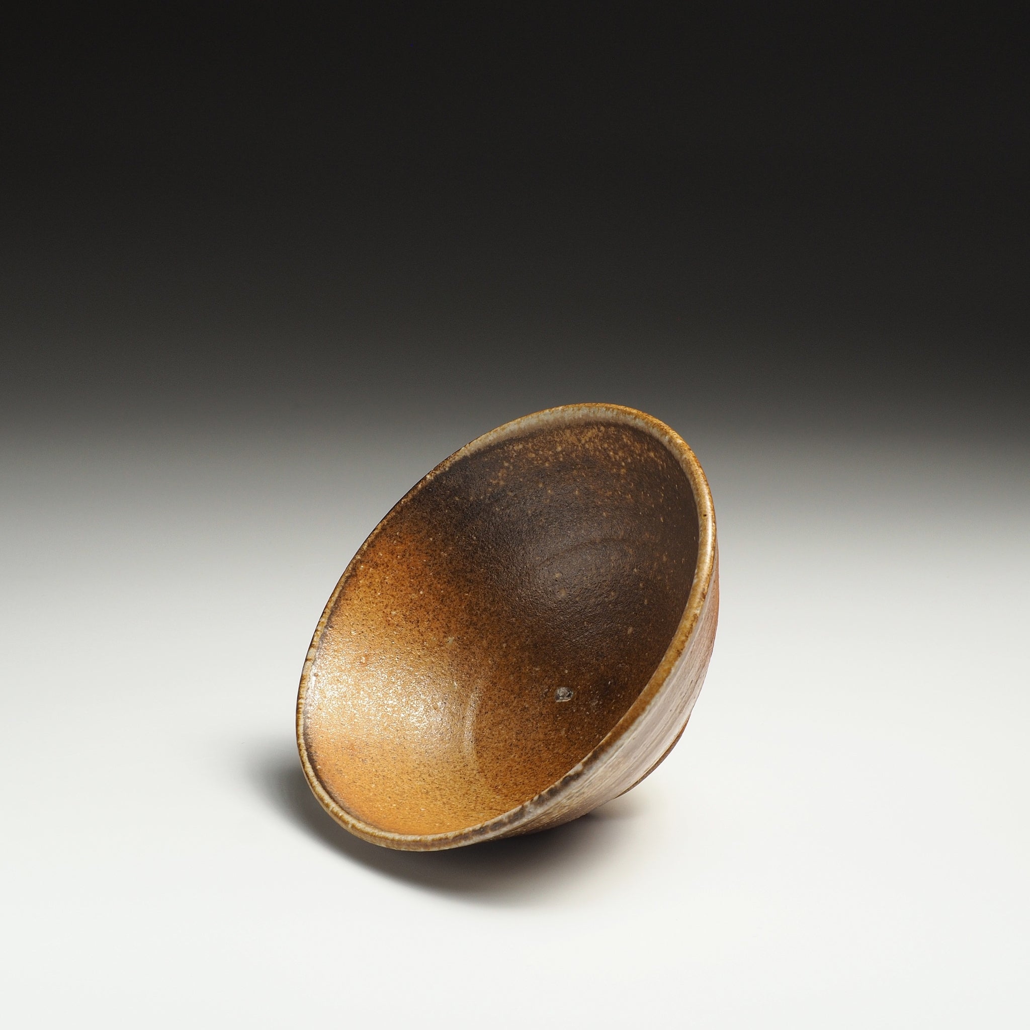Interior view of a Mizuho handmade Shigaraki rice bowl showing its deep brown inner surface.