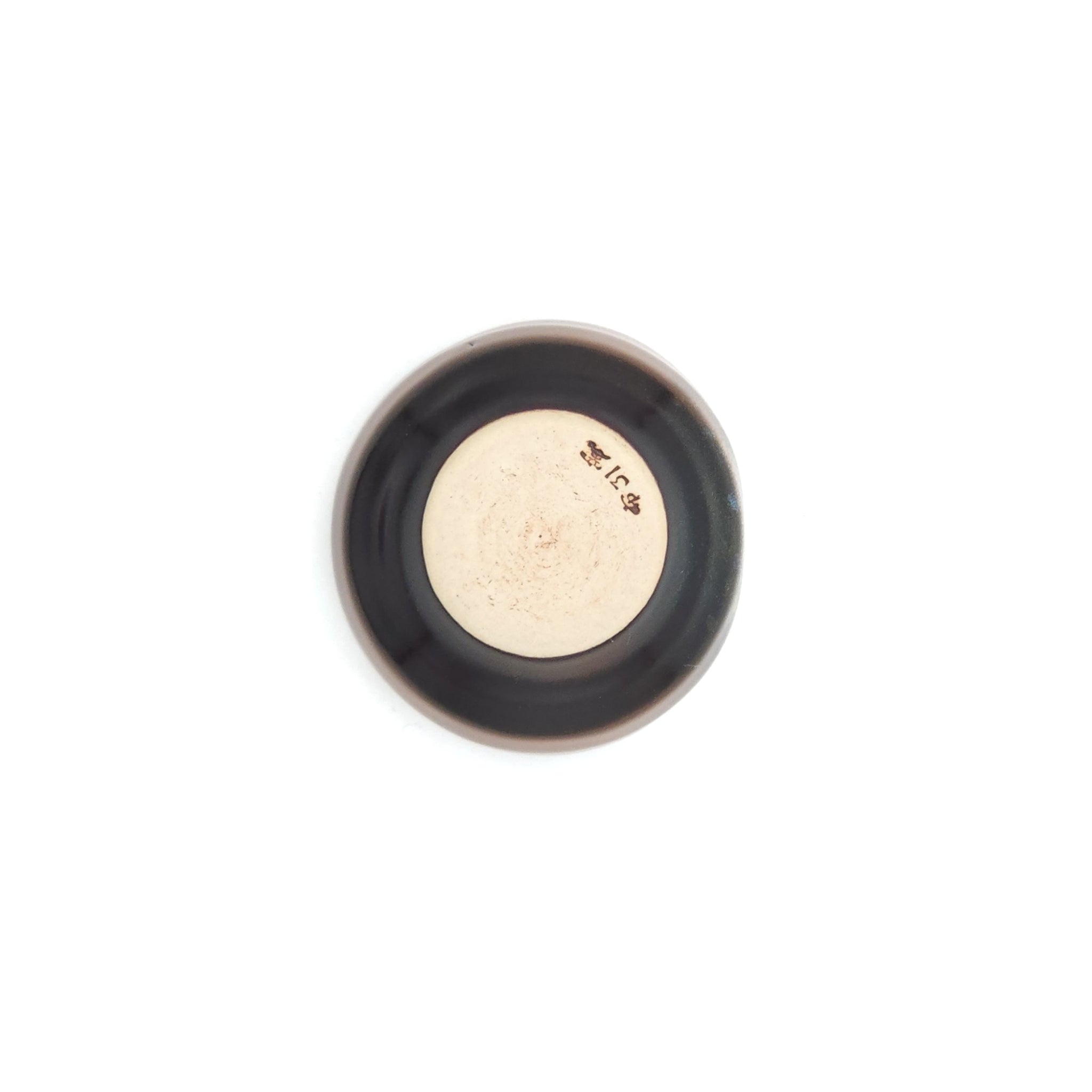 A bottom view of a Japanese round sake cup (brown). Tsukushi