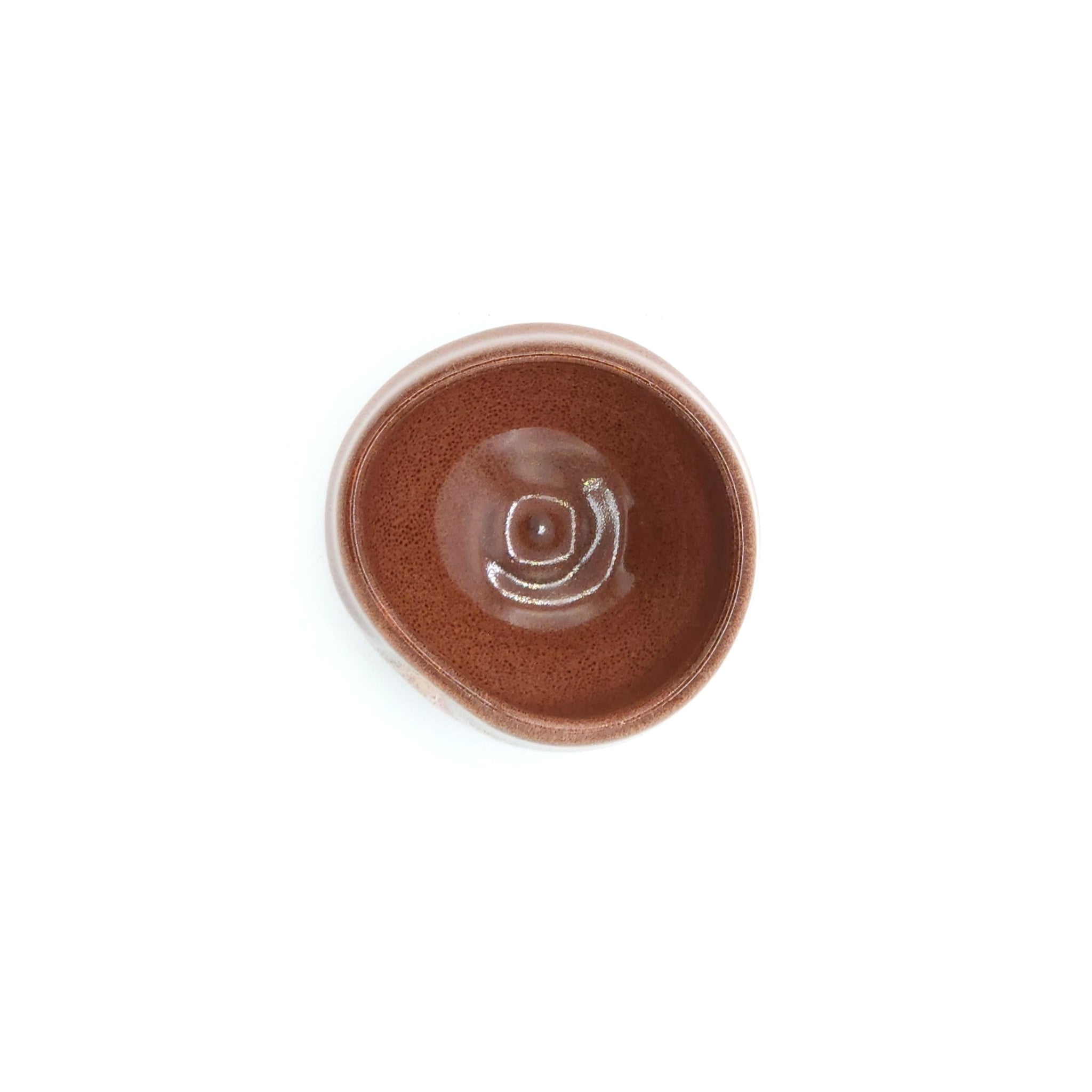 A top view of a Japanese round sake cup (brown). Tsukushi