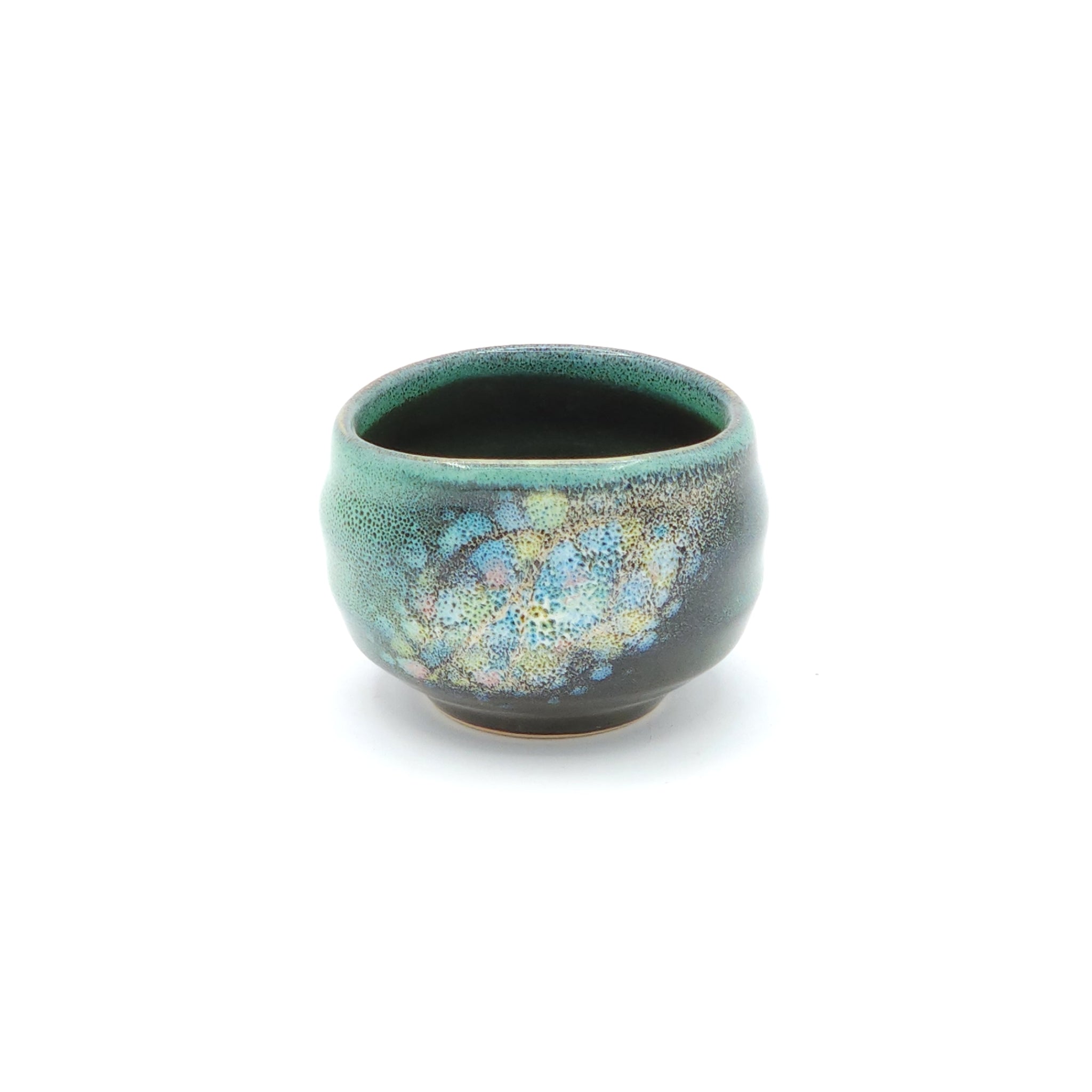 A green Japanese round sake cup on a white back ground. Tsukushi