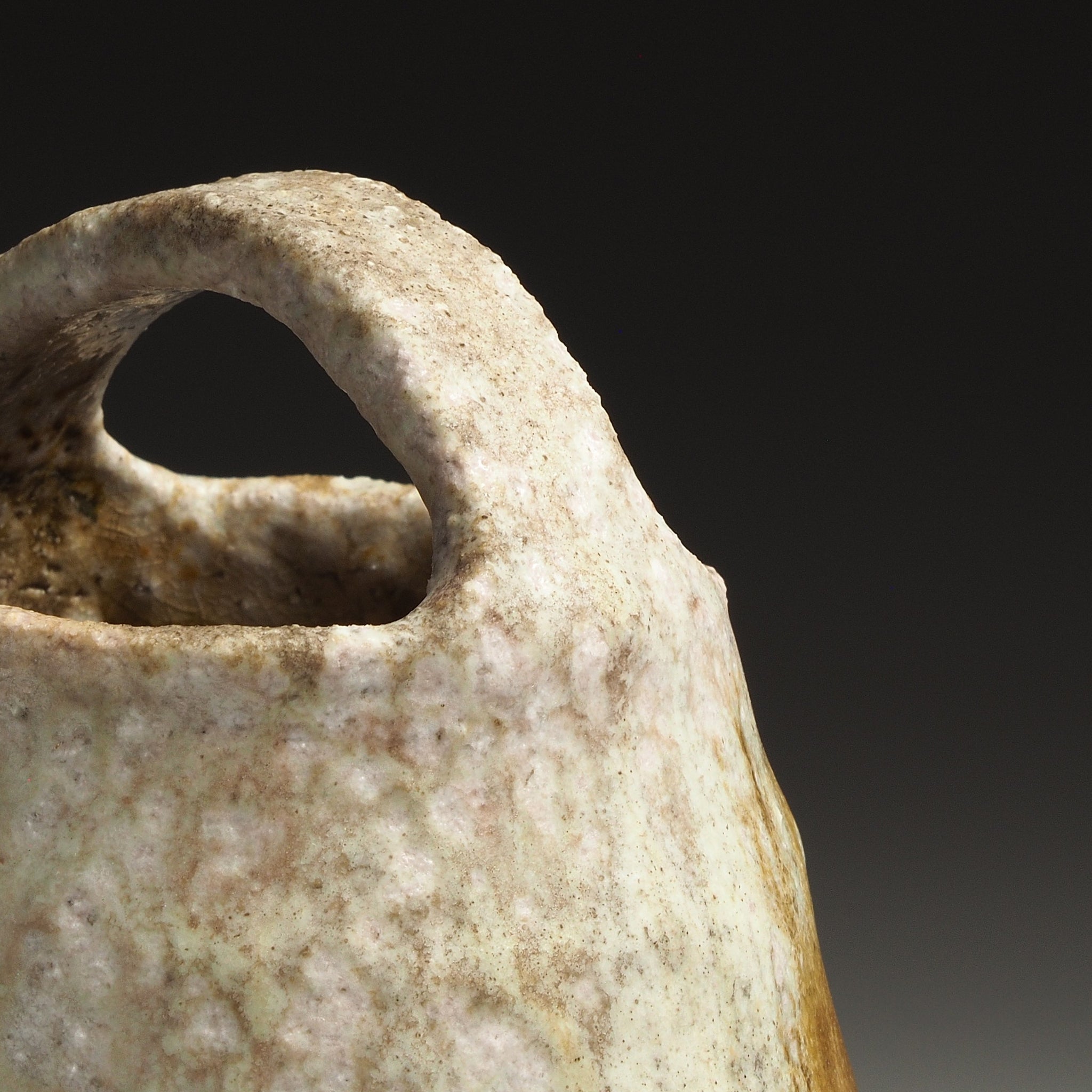 Close-up of the Setsugan handmade Shigaraki vase showing the loop handle and textured natural ash-fired surface.