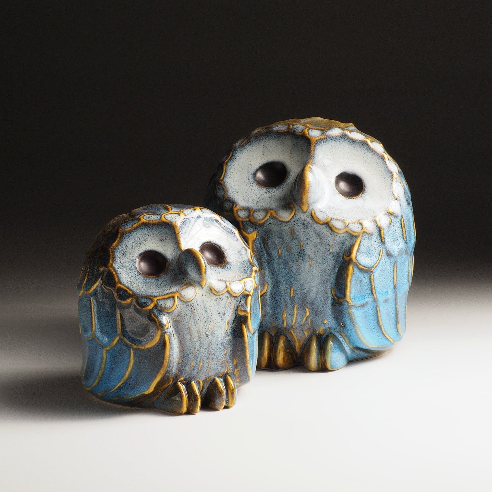 Sofuku ceramic owl pair arranged with the smaller owl in front and the larger owl behind