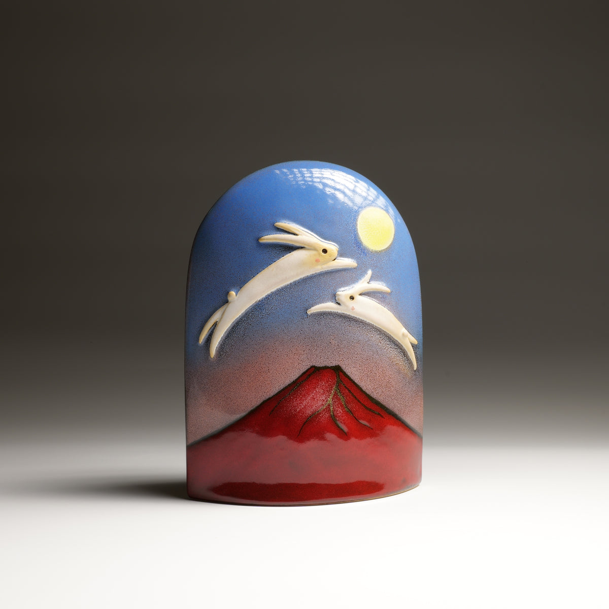 Tsukimi ceramic ornament by Kazuhiro Kojima, front view with white rabbits, full moon and red Mount Fuji.
