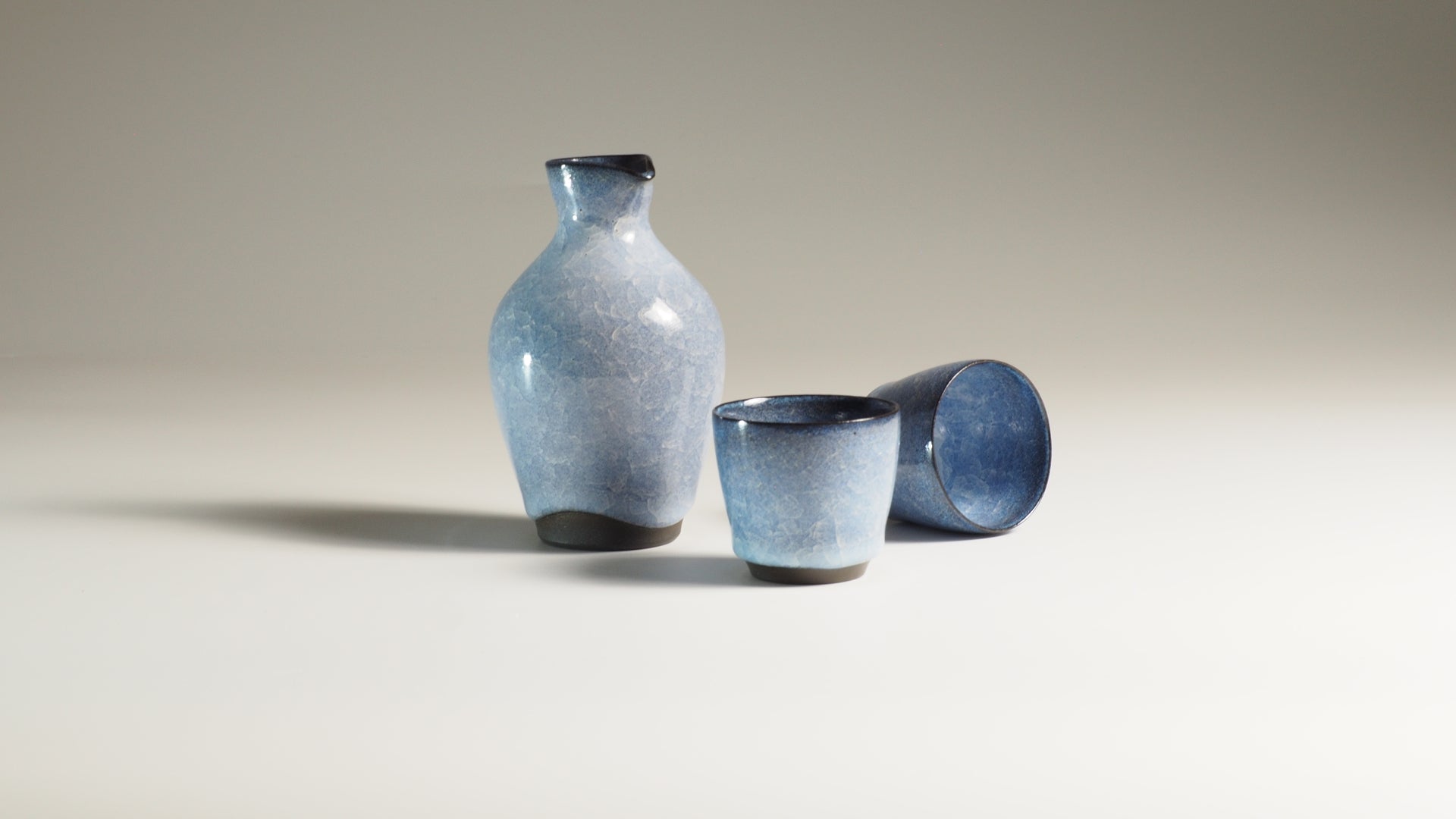 Japanese Sake Set featuring tokkuri carafe and ochoko cup on a fading background | Tsukushi