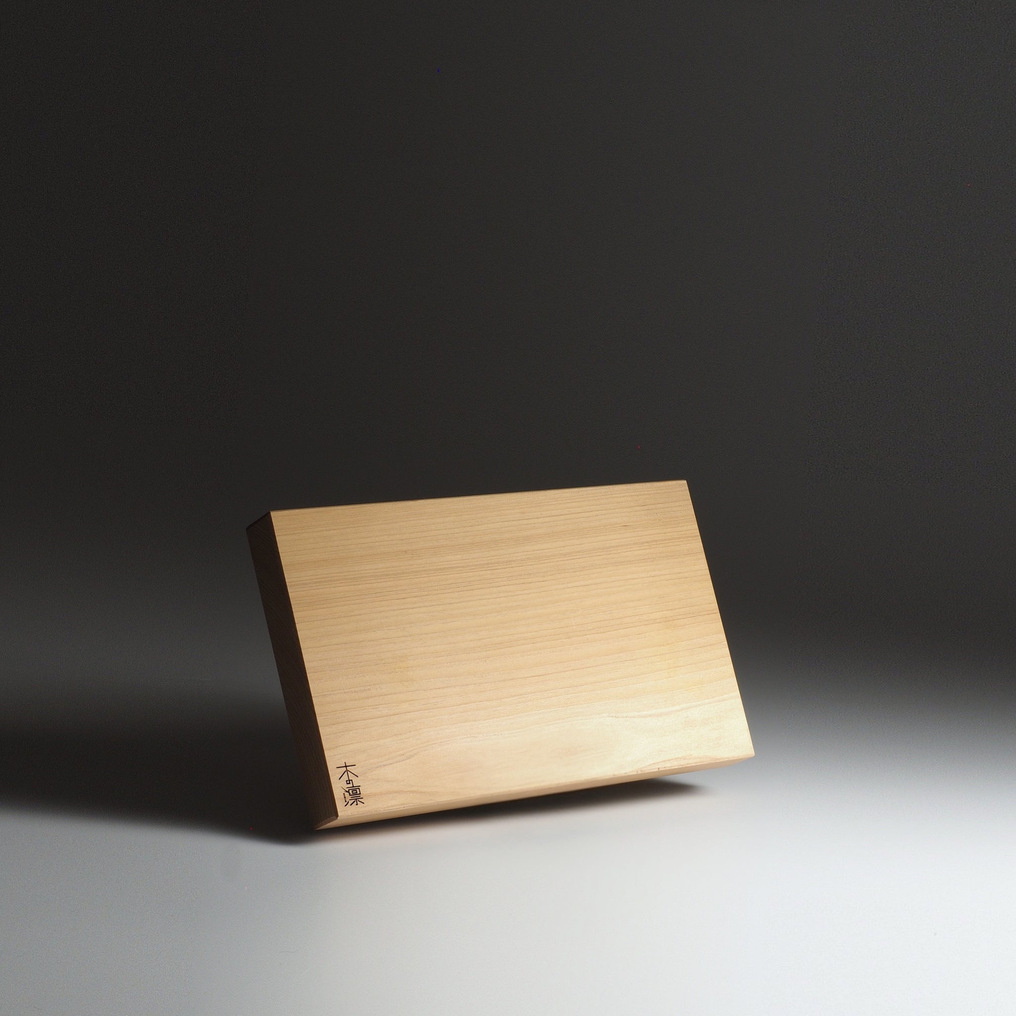 Japanese wooden cutting board, S size, with engraved text on a dark background