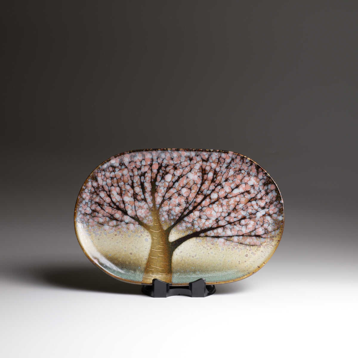 Front view of the Hanami handmade Japanese ceramic plate, highlighting the spreading cherry blossom branches and gently irregular outline.