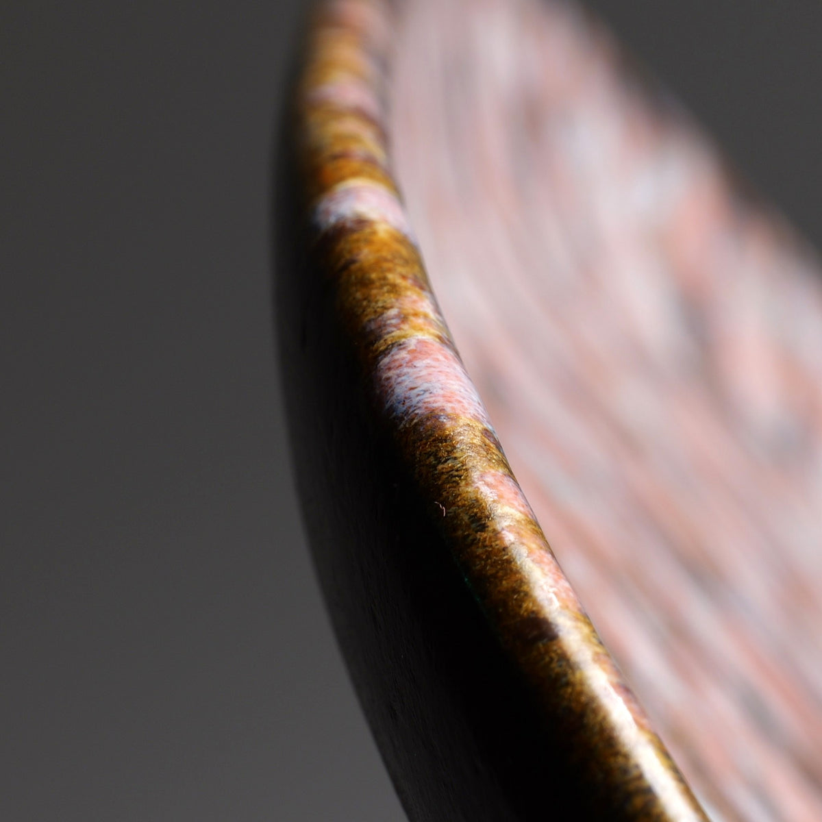 Detail of the edge of the Japanese handmade ceramic plate Hanami, with sakura decorations.