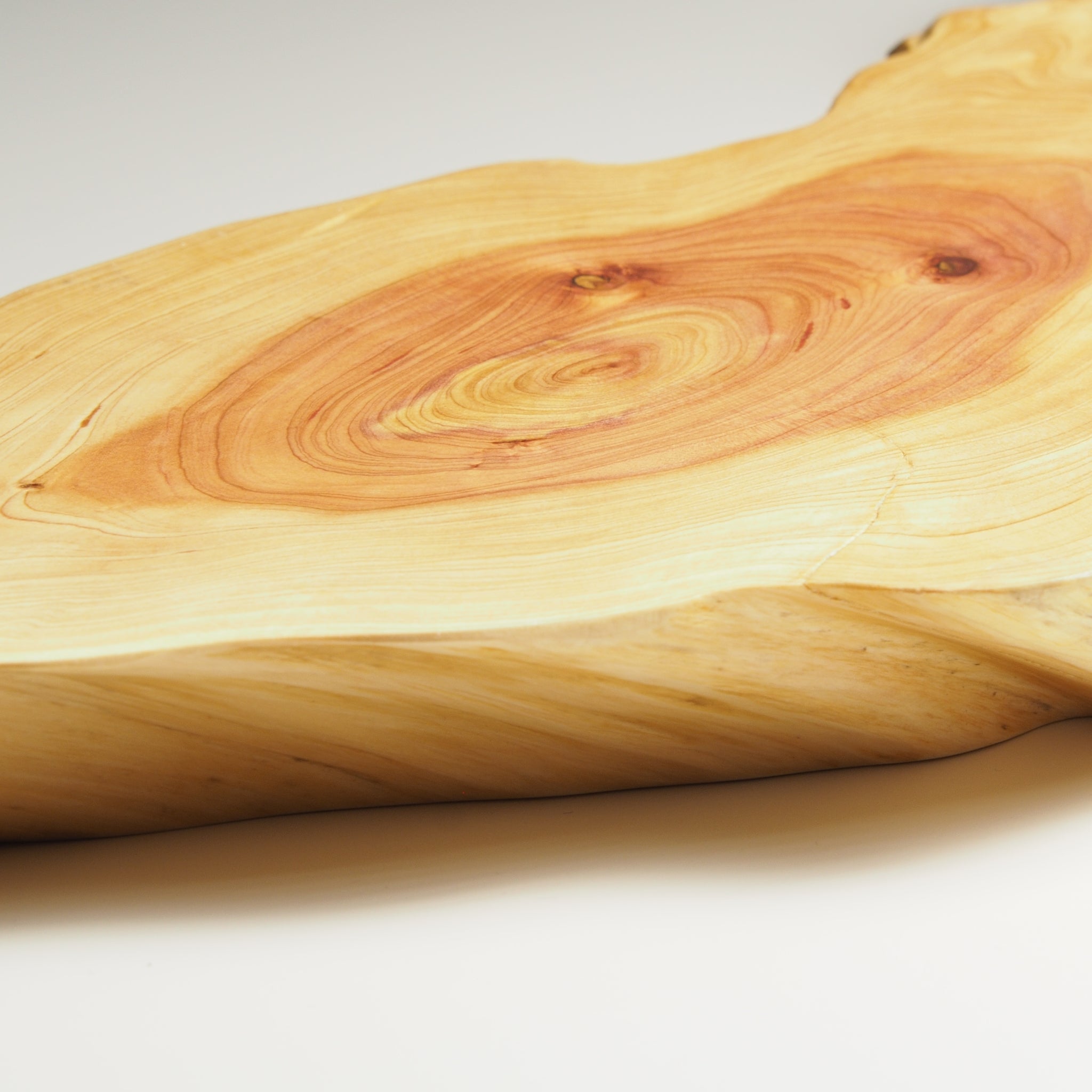 Close-up of a Japanese wooden sushi tray to see wooden surface with visible grain and texture. Tsukushi