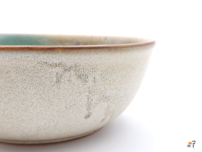 Authentic Japanese pottery salad bowl with cherry blossoms decoration. green and beige color. (side detail view 1).