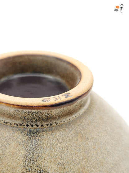 Authentic Japanese pottery bowl with cherry blossoms decoration. Green and beige color. (bottom detail 1)