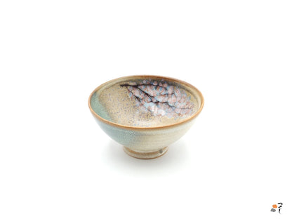 Authentic Japanese pottery bowl with cherry blossoms decoration. Green and beige color. (side view 5).