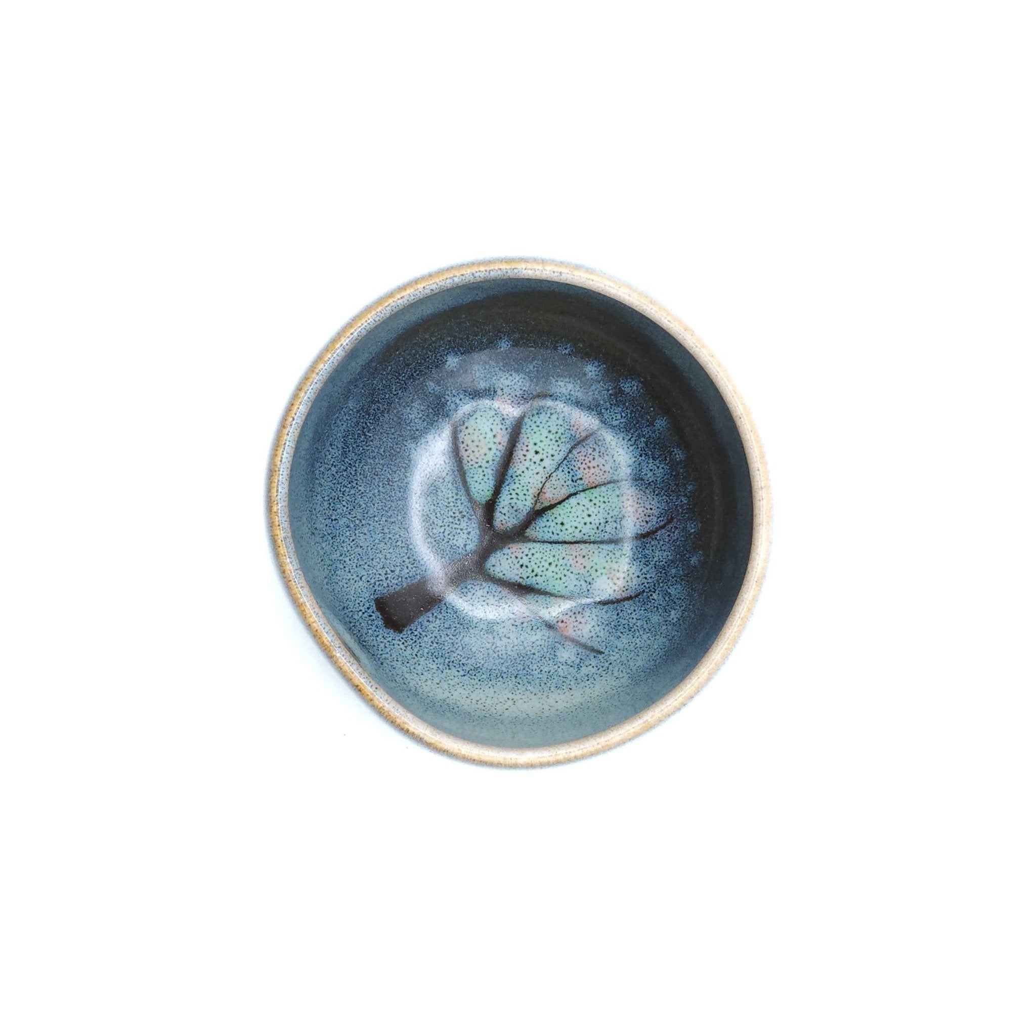 Authentic Japanese pottery teacup with tree decoration. blue and white color.  (top view 1).