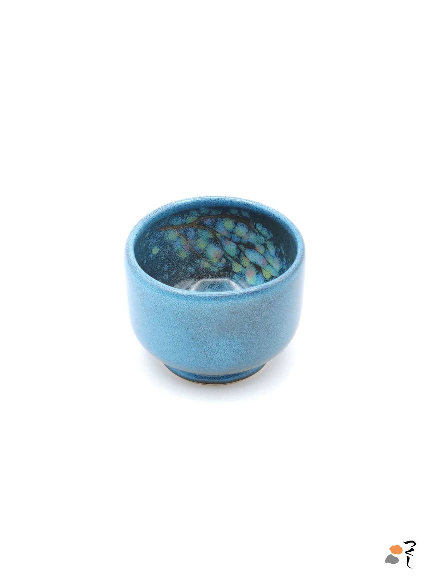 Authentic Japanese pottery teacup with tree pattern decoration. blue color. (front side view 1).