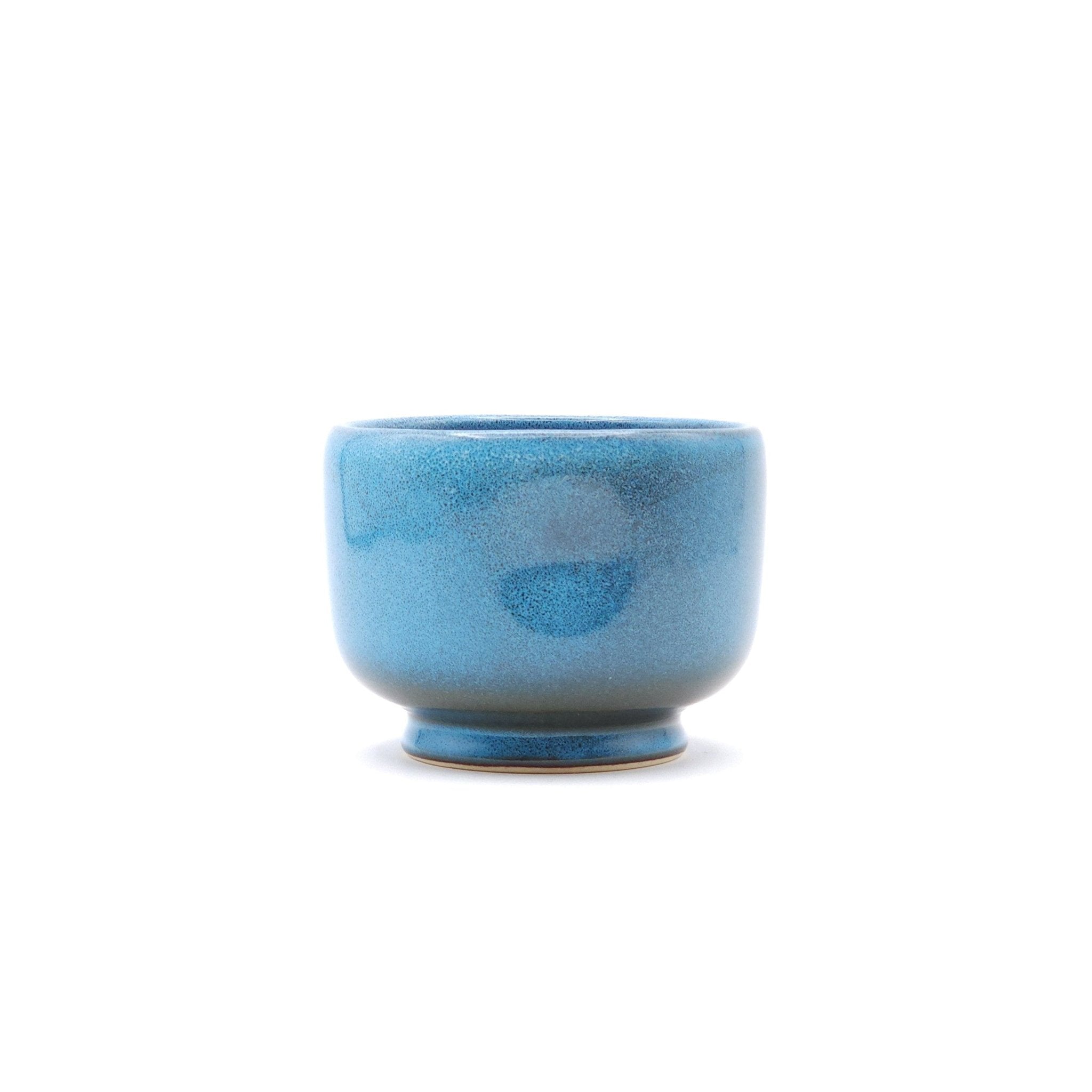 Authentic Japanese pottery teacup with tree pattern decoration. blue color. (side view 1).