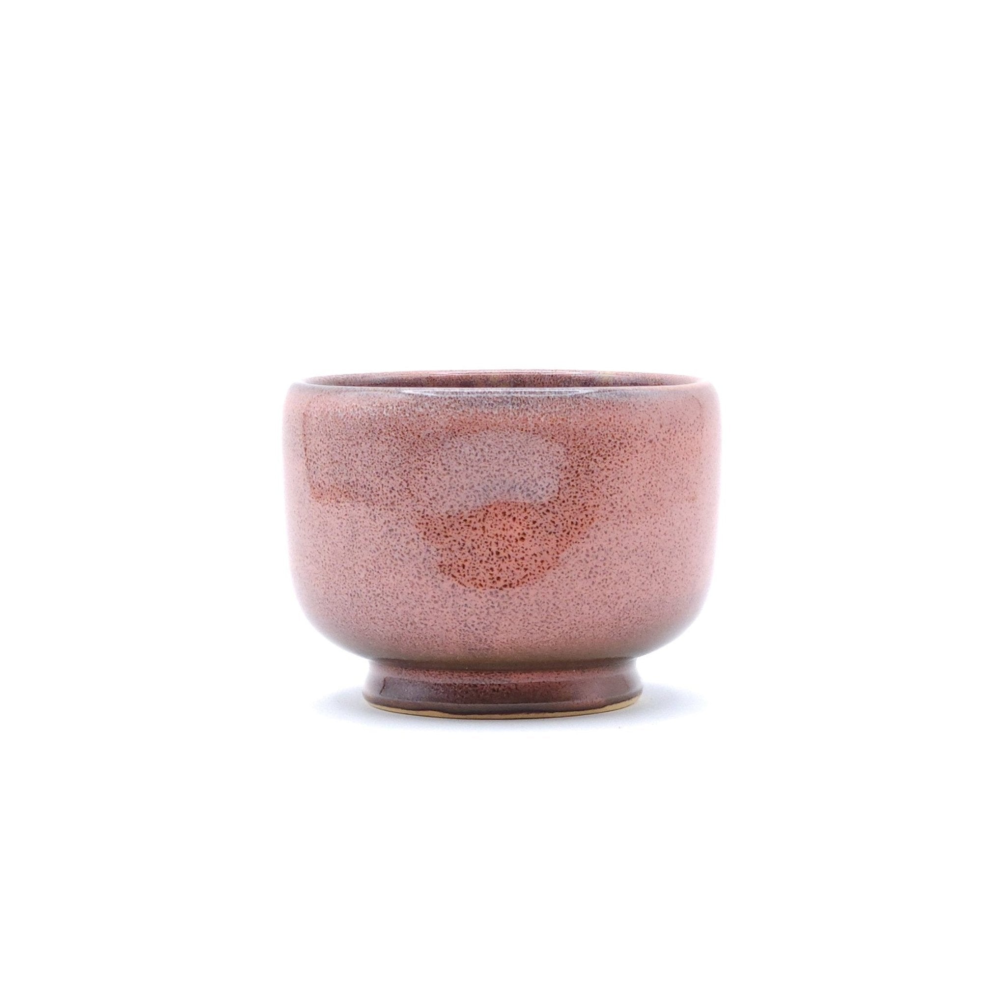 Authentic Japanese pottery teacup with tree pattern decoration. pink color. (side view 1).