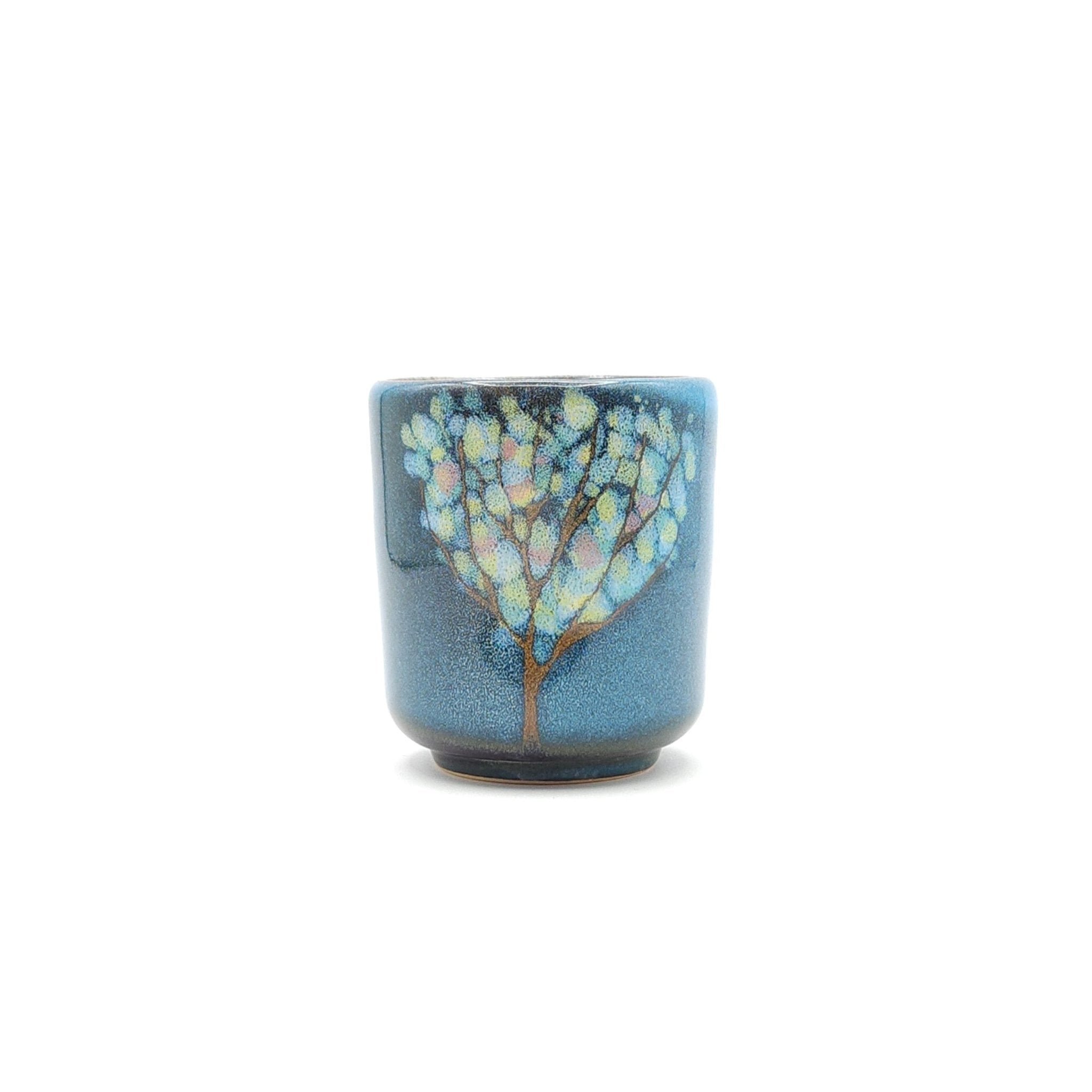 Authentic Japanese pottery teacup tall with tree pattern decoration. blue color. (side view 3).