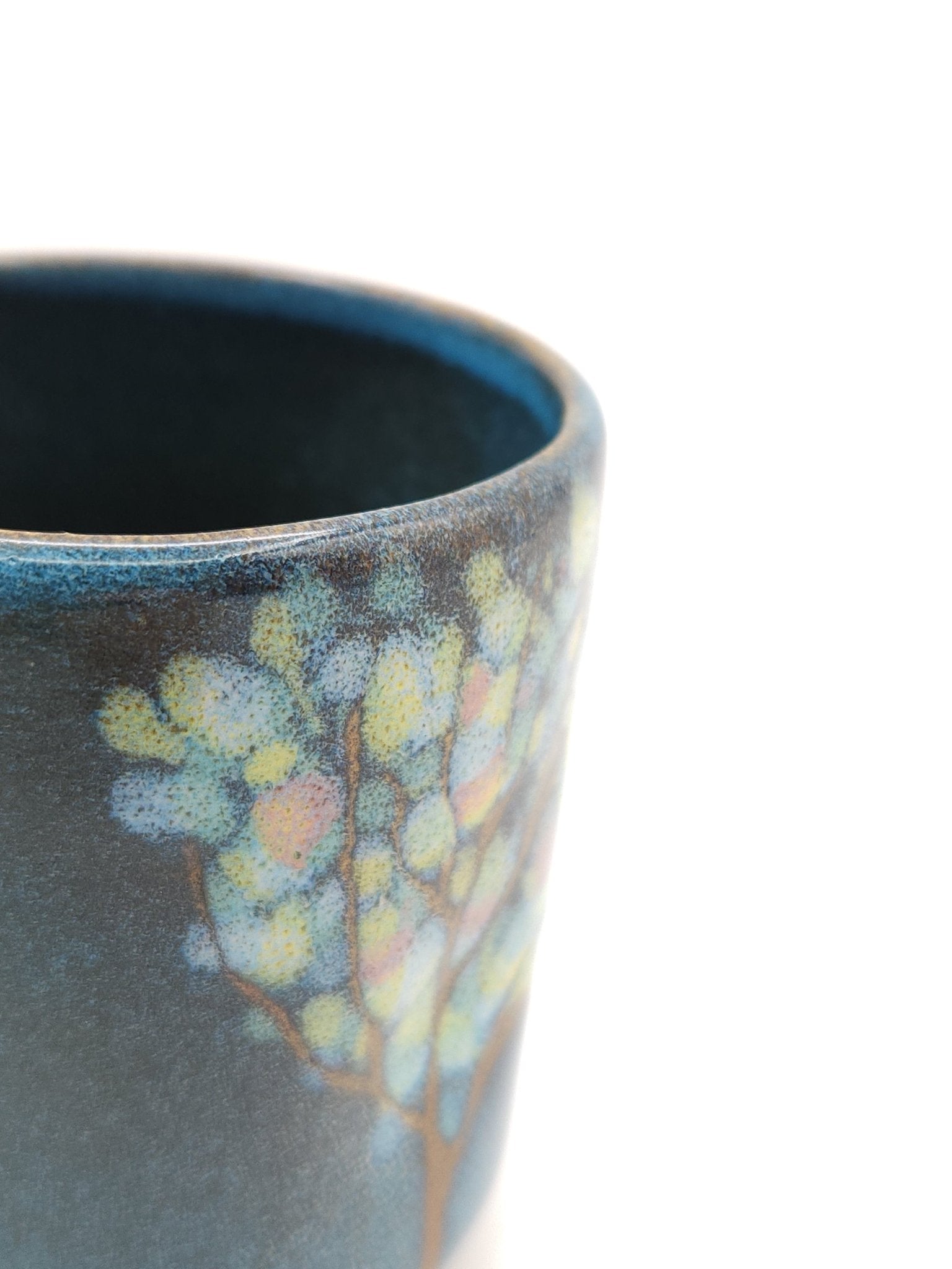 Authentic Japanese pottery teacup tall with tree pattern decoration. blue color.  (side detail view 1).