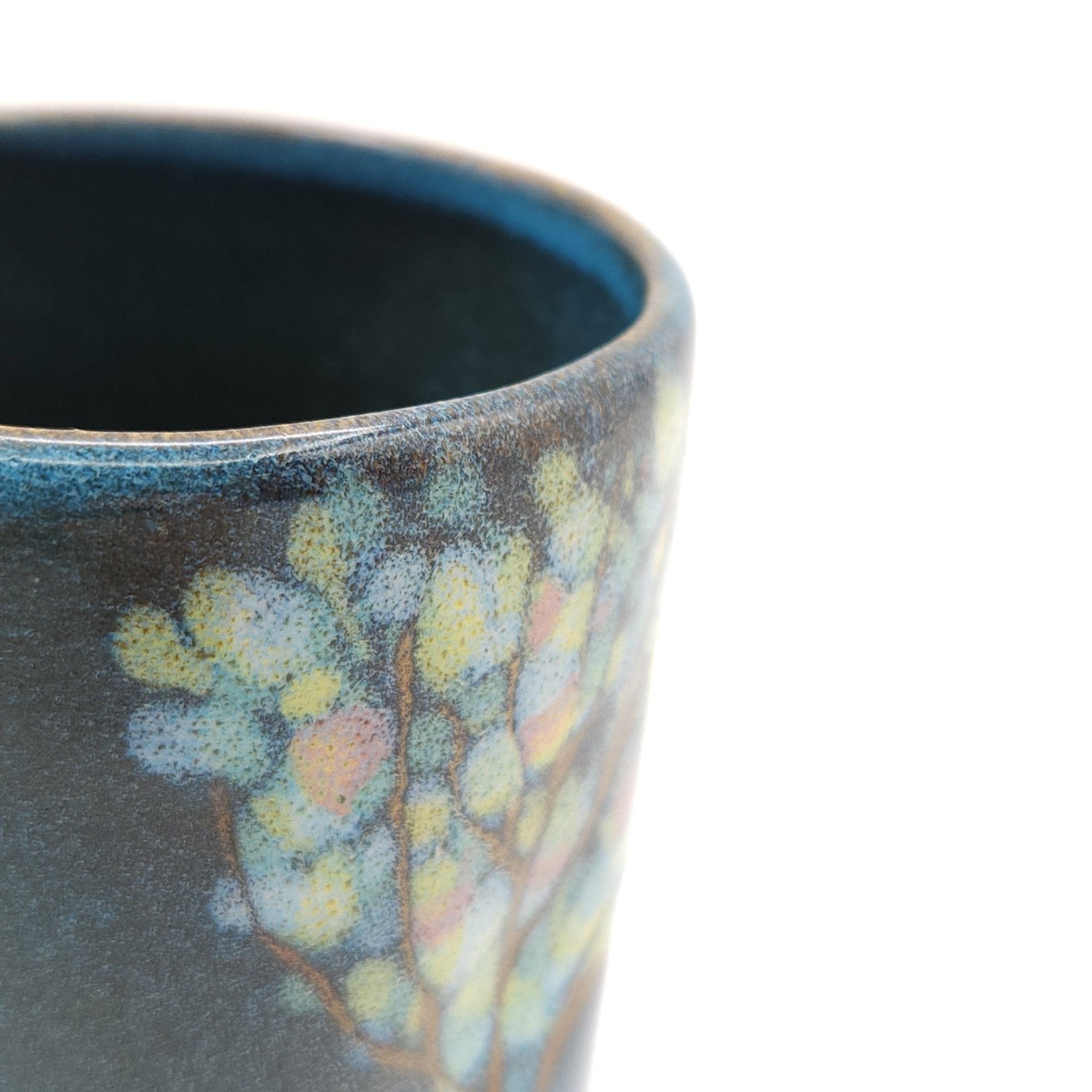 Authentic Japanese pottery teacup tall with tree pattern decoration. blue color.  (side detail view 1).