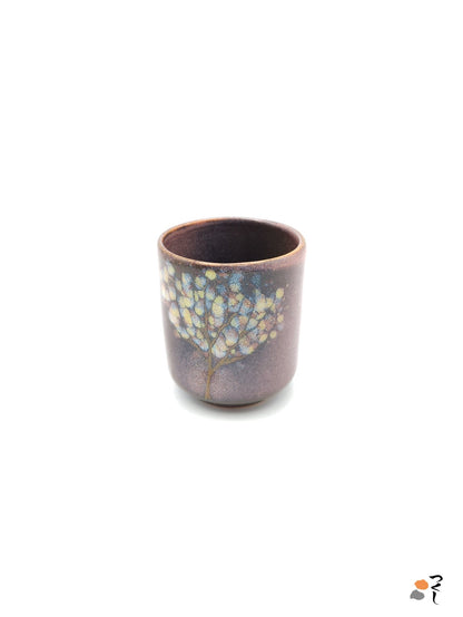 Authentic Japanese pottery teacup tall with tree pattern decoration. pink color. (side view 1).