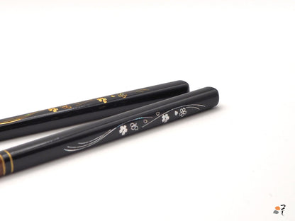 Detail of black Japanese chopsticks with cherry blossom motifs