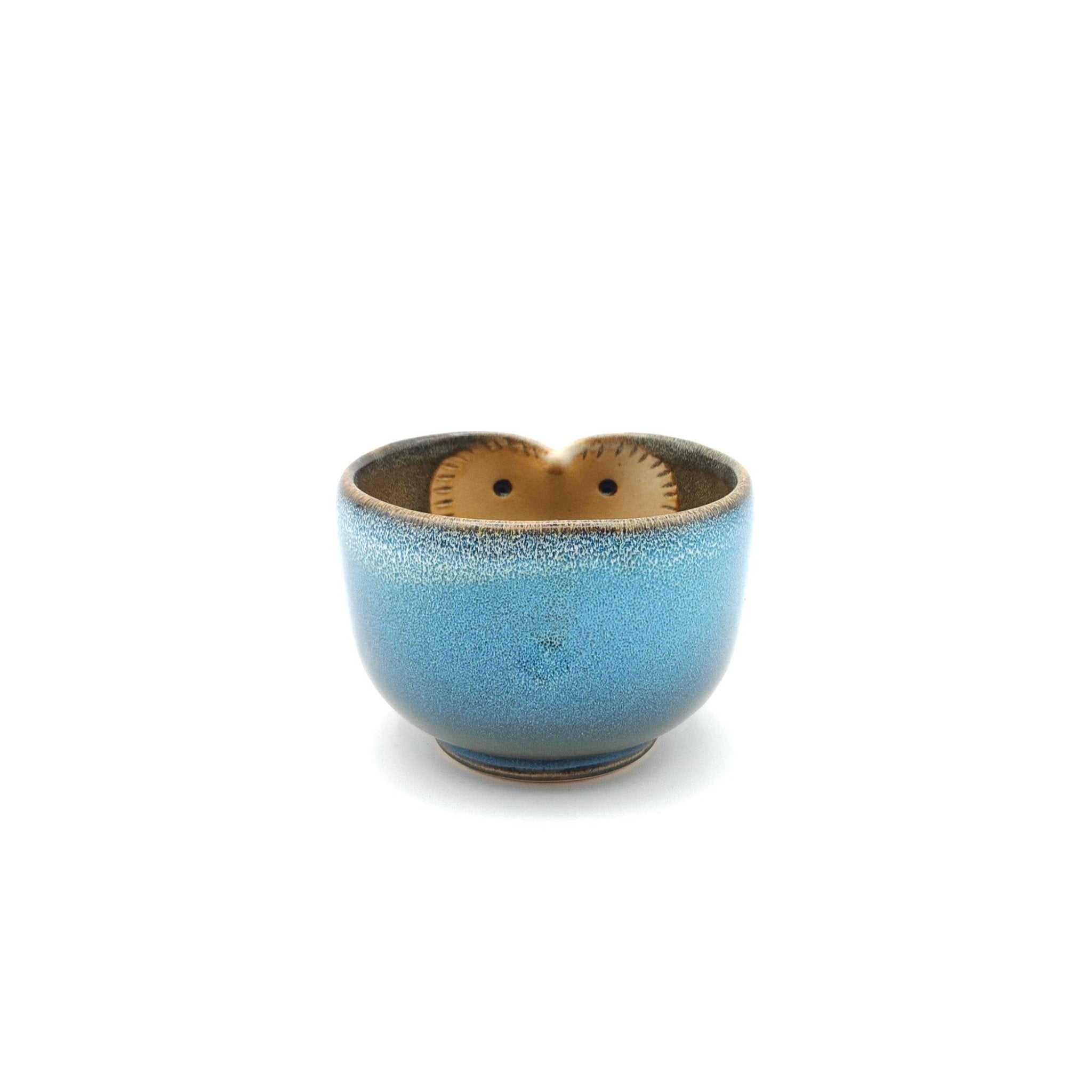 Front view of a Japanese blue Teacup made of pottery with an Owl motif.