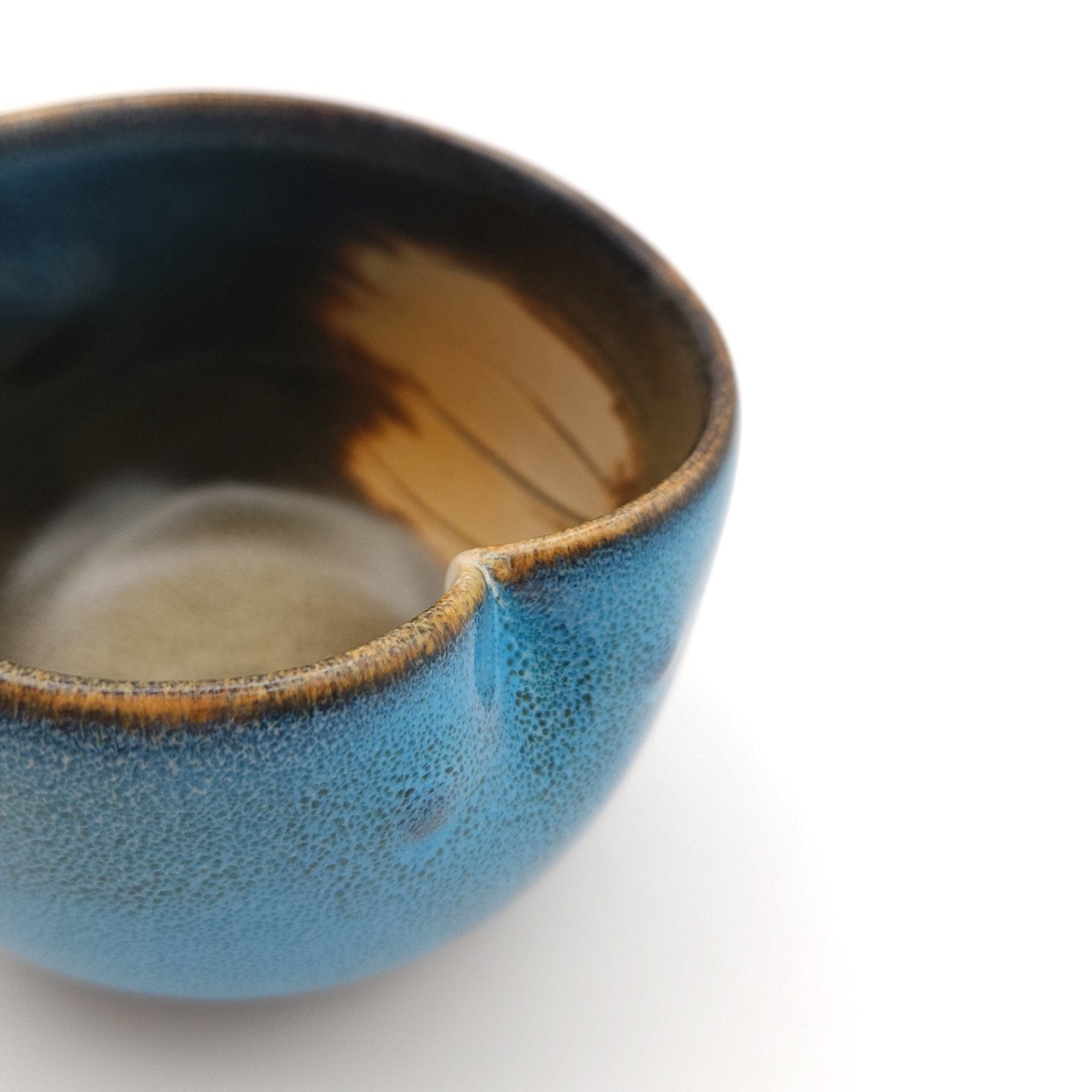 Side view of a Japanese blue Teacup made of pottery with an Owl motif.
