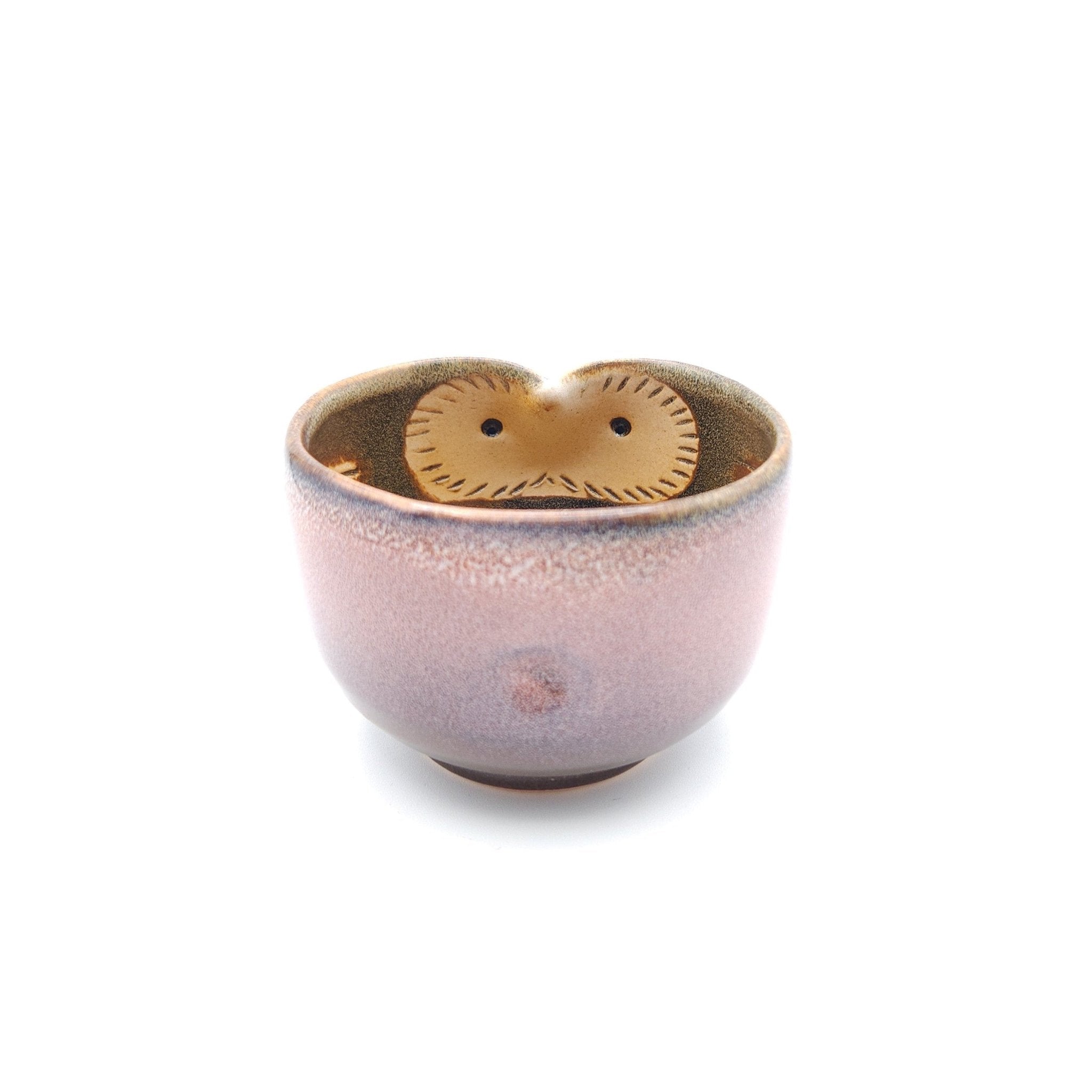 Front view of a Japanese pink Teacup made of pottery with an Owl motif.