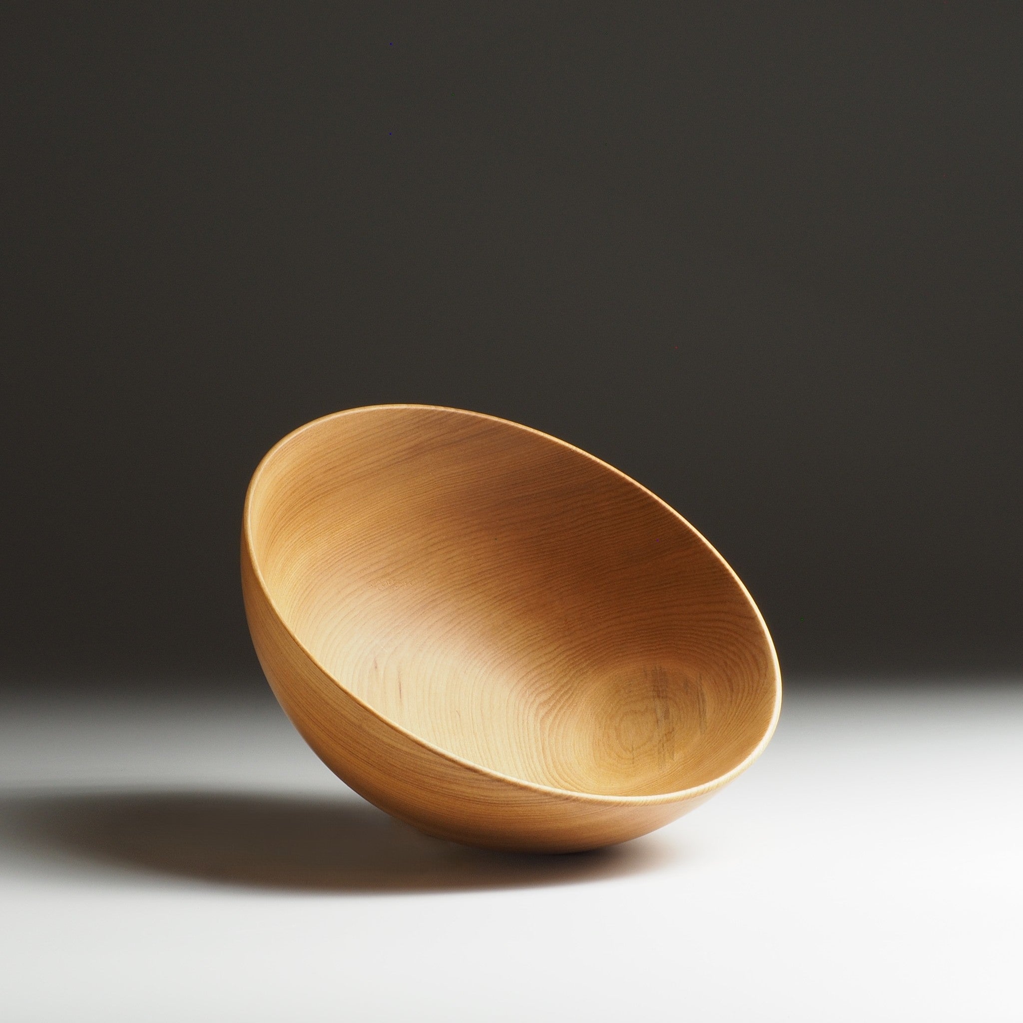 Japanese wooden bowl on a dark background. Tsukushi