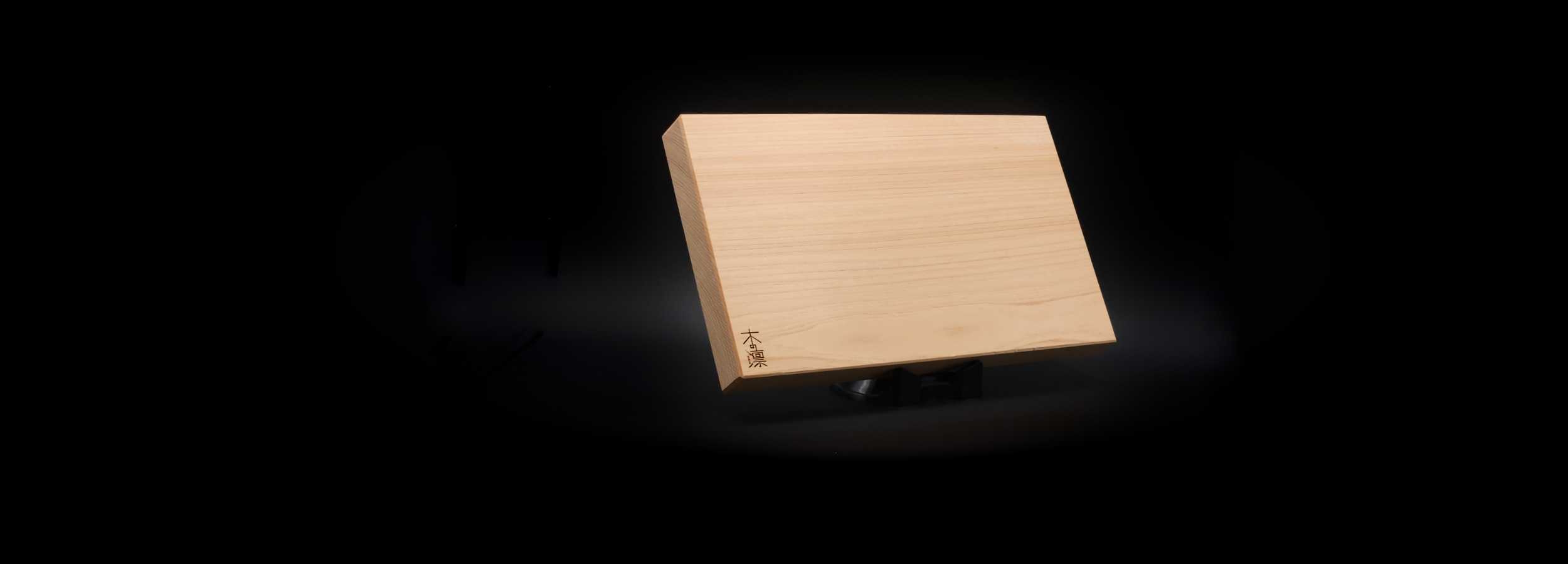 Hinoki wood Japanese cutting board black background, Tsukushi