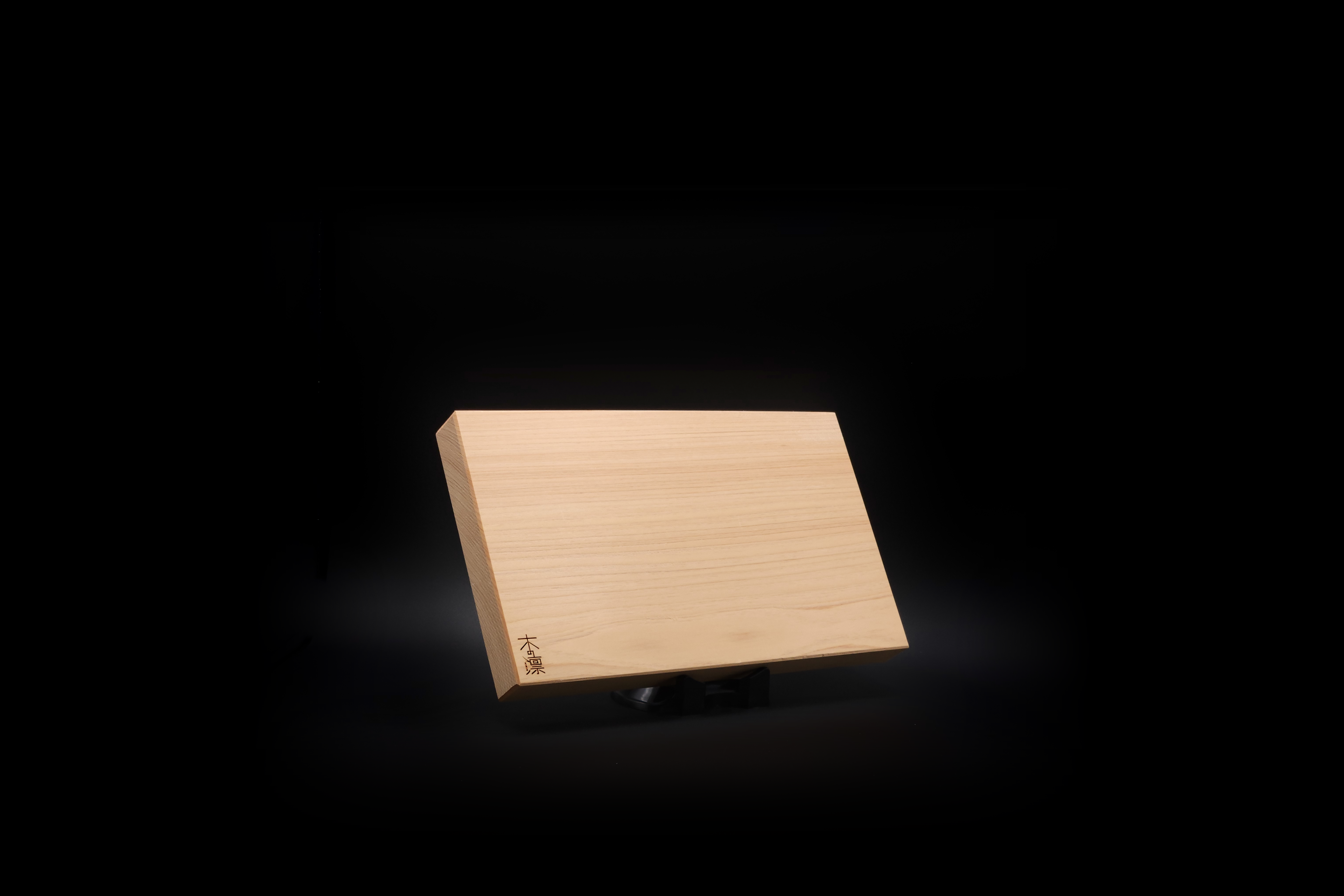 Japanese chopping board (Manaita) on black background.