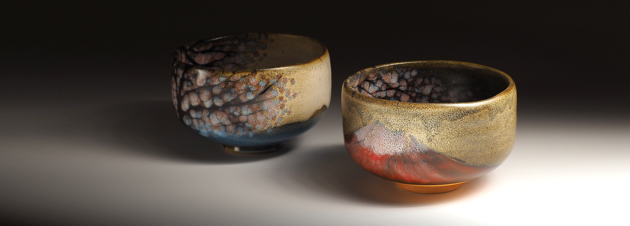 Two matcha Bowls with textured surfaces on a gradient background. Tsukushi