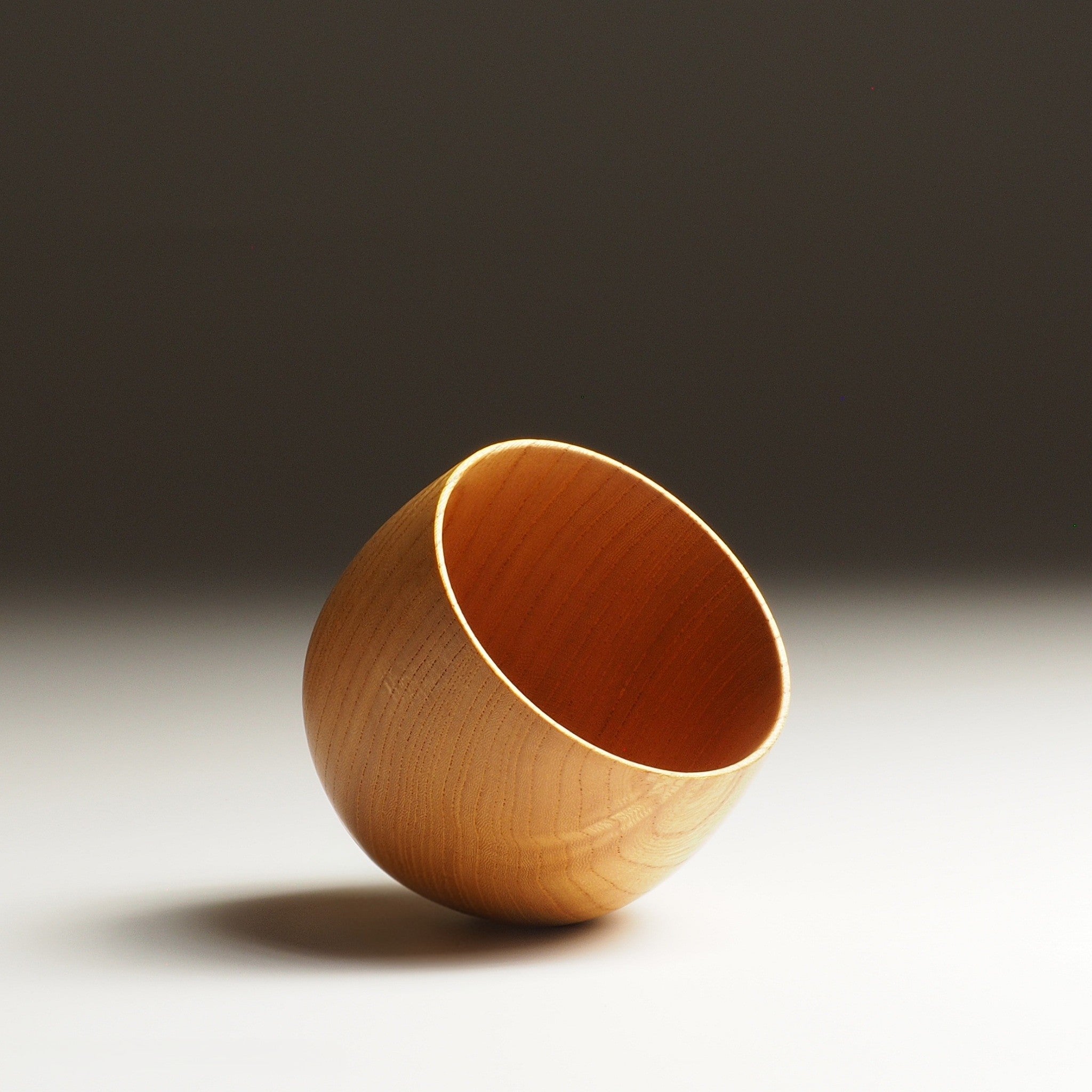 Japanese wood cup on a gradient background. Tsukushi