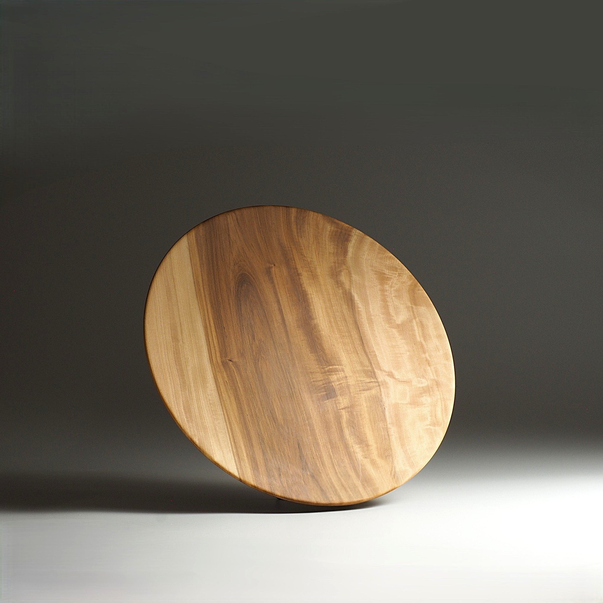Front view of Japanese wooden dinner plate on a gray gradation background. Tsukushi