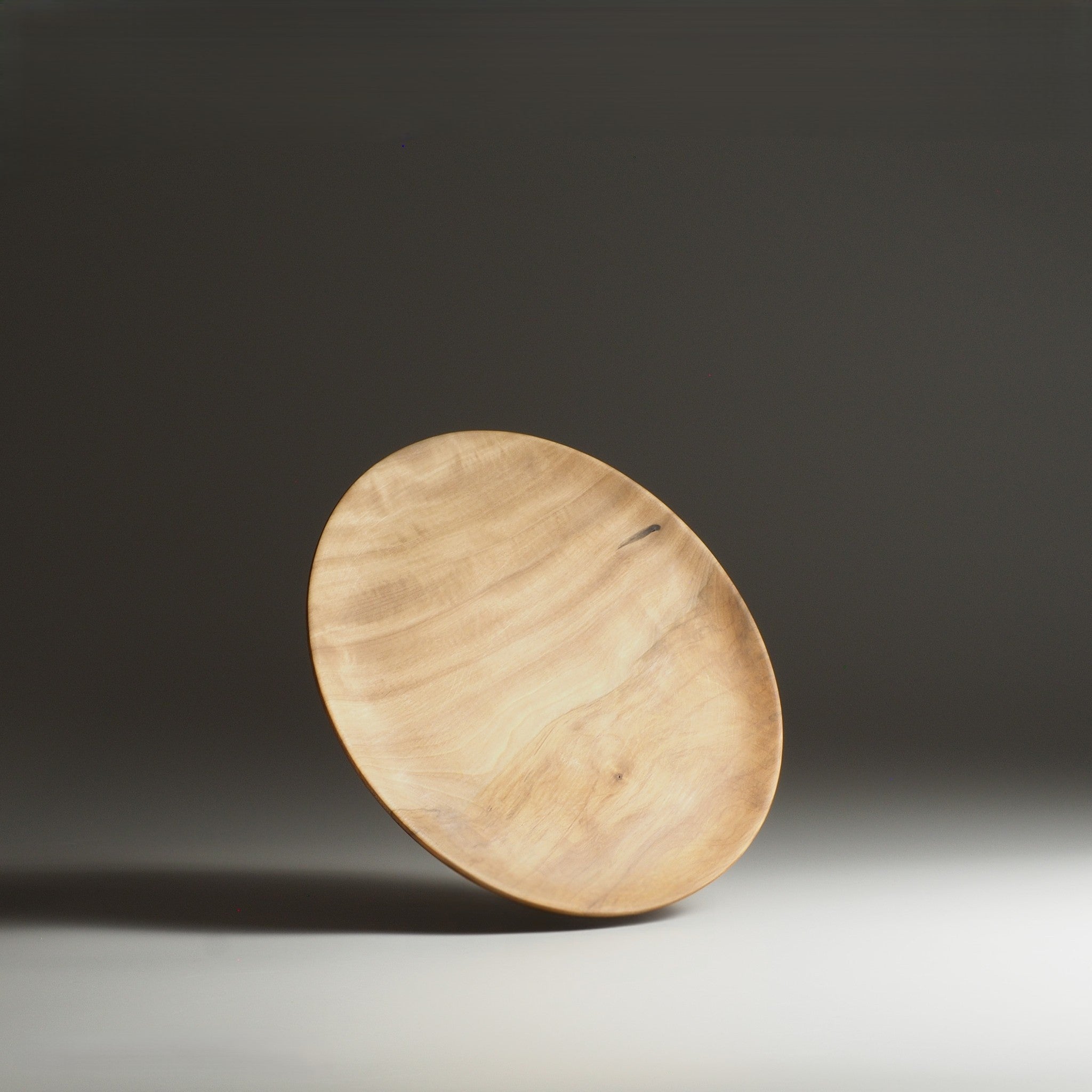 Front view of Japanese wood plate on a gray gradation background. Tsukushi