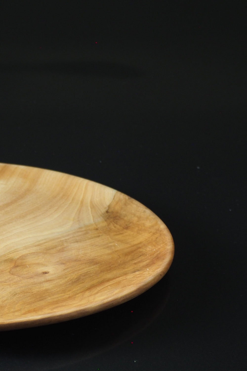 Japanese wooden dinner plate on a black background. Tsukushi
