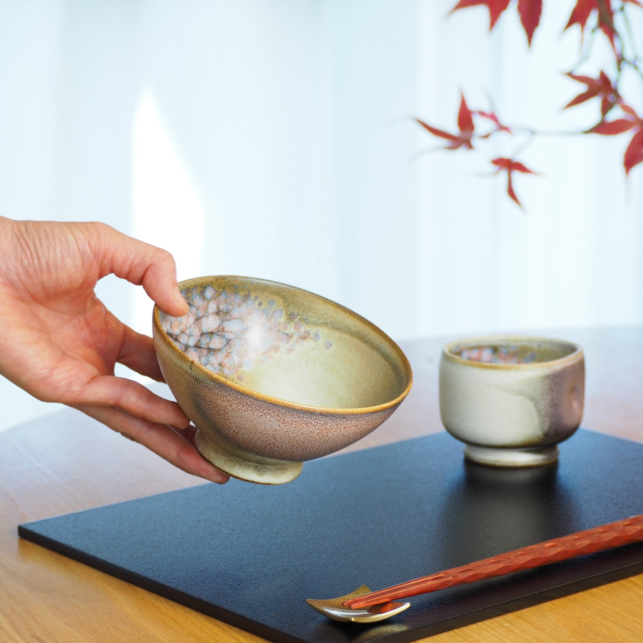 Japanese ceramic rice small bowl in pink held by a woman hand