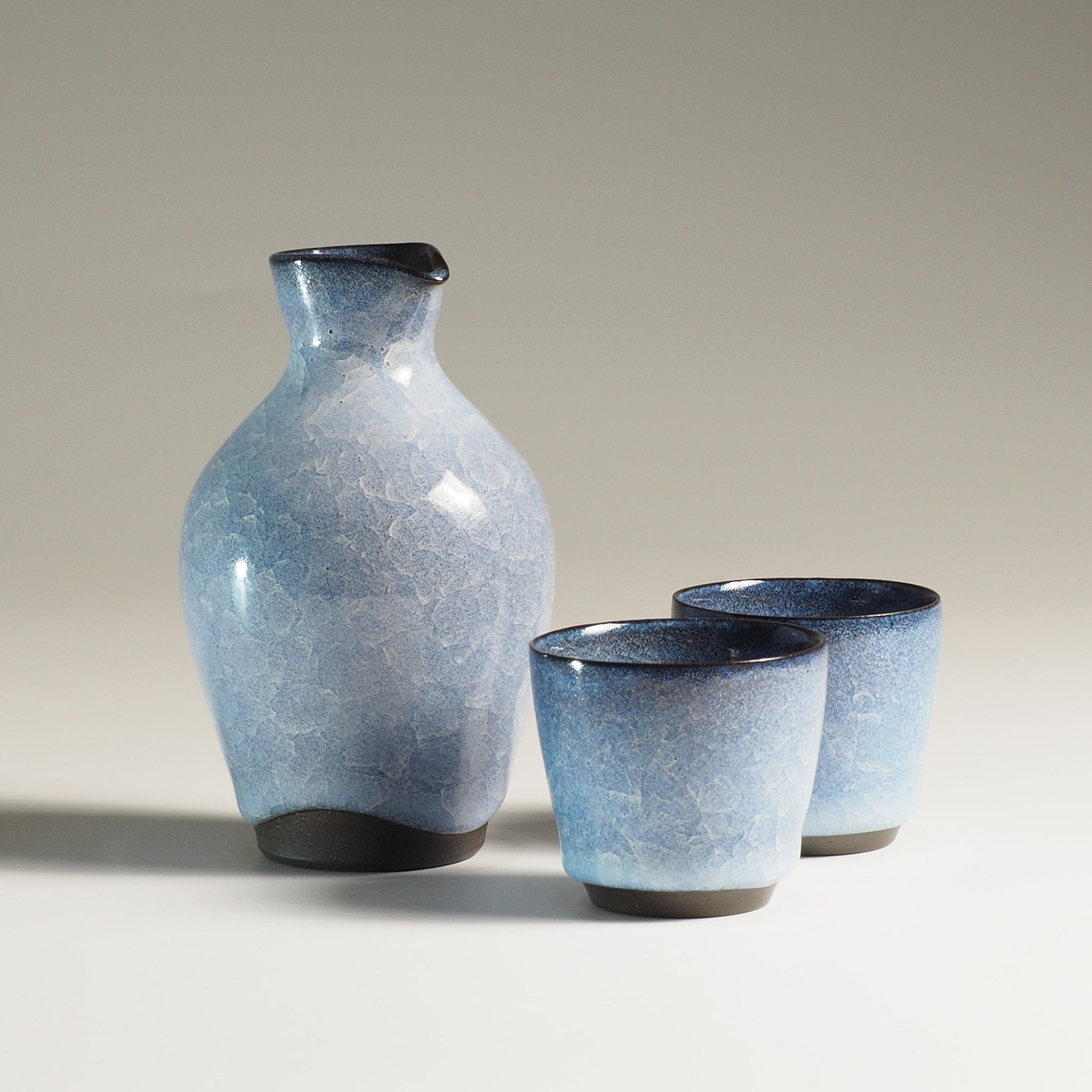 Japanese handcrafted crazing ceramic Sake set beige gradation background , Tsukushi