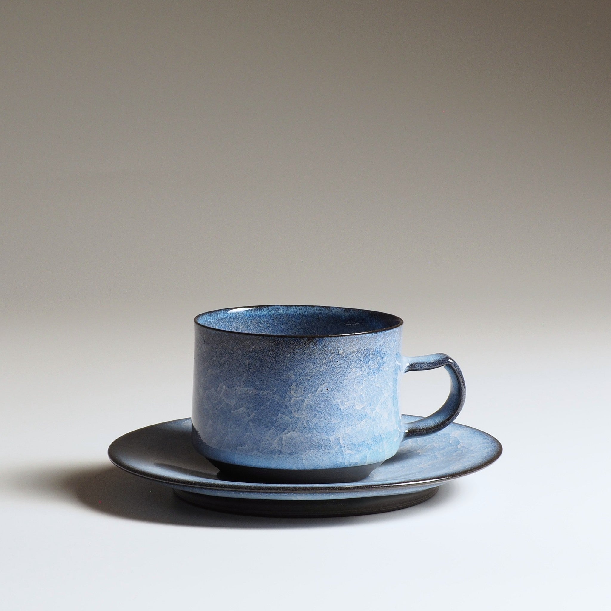 Handcrafted crazing Japanese ceramic coffee cup beige background, Tsukushi